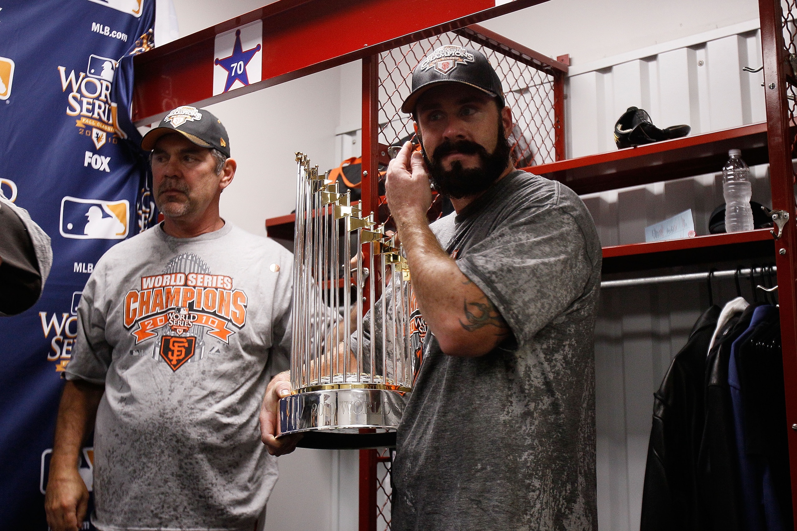 ARLINGTON, TX - NOVEMBER 01:  (L-R) Manager Bruce Bochy and Brian Wilson #28 of the San Francisco Giants celebrate with the World Series trophy in the locker room after the Giants won 3-1 against the Texas Rangers in Game Five of the 2010 MLB World Series
