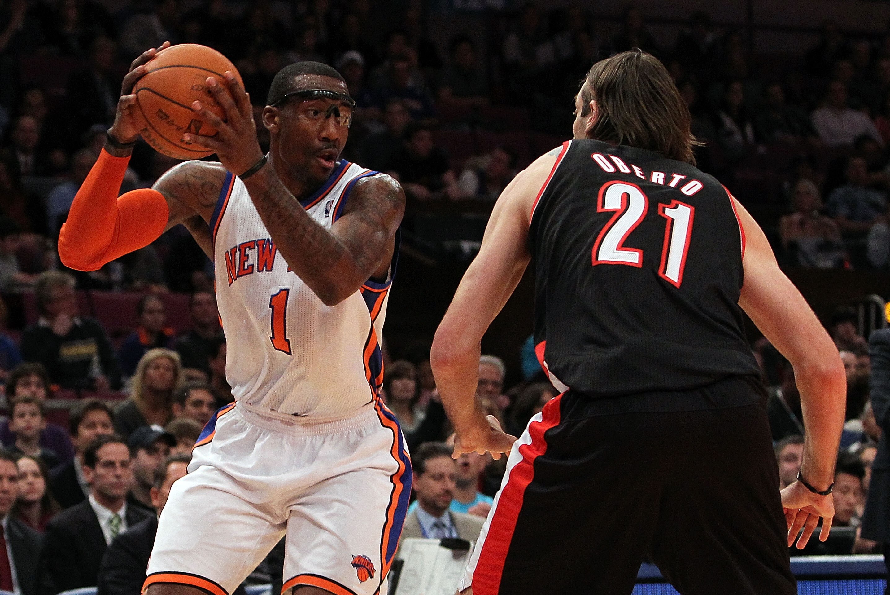 NEW YORK - OCTOBER 30:  Amar'e Stoudemire #1 of the New York Knicks drives against Fabricio Oberto #21 of the Portland Trail Blazers at Madison Square Garden on October 30, 2010 in New York City. NOTE TO USER: User expressly acknowledges and agrees that, 