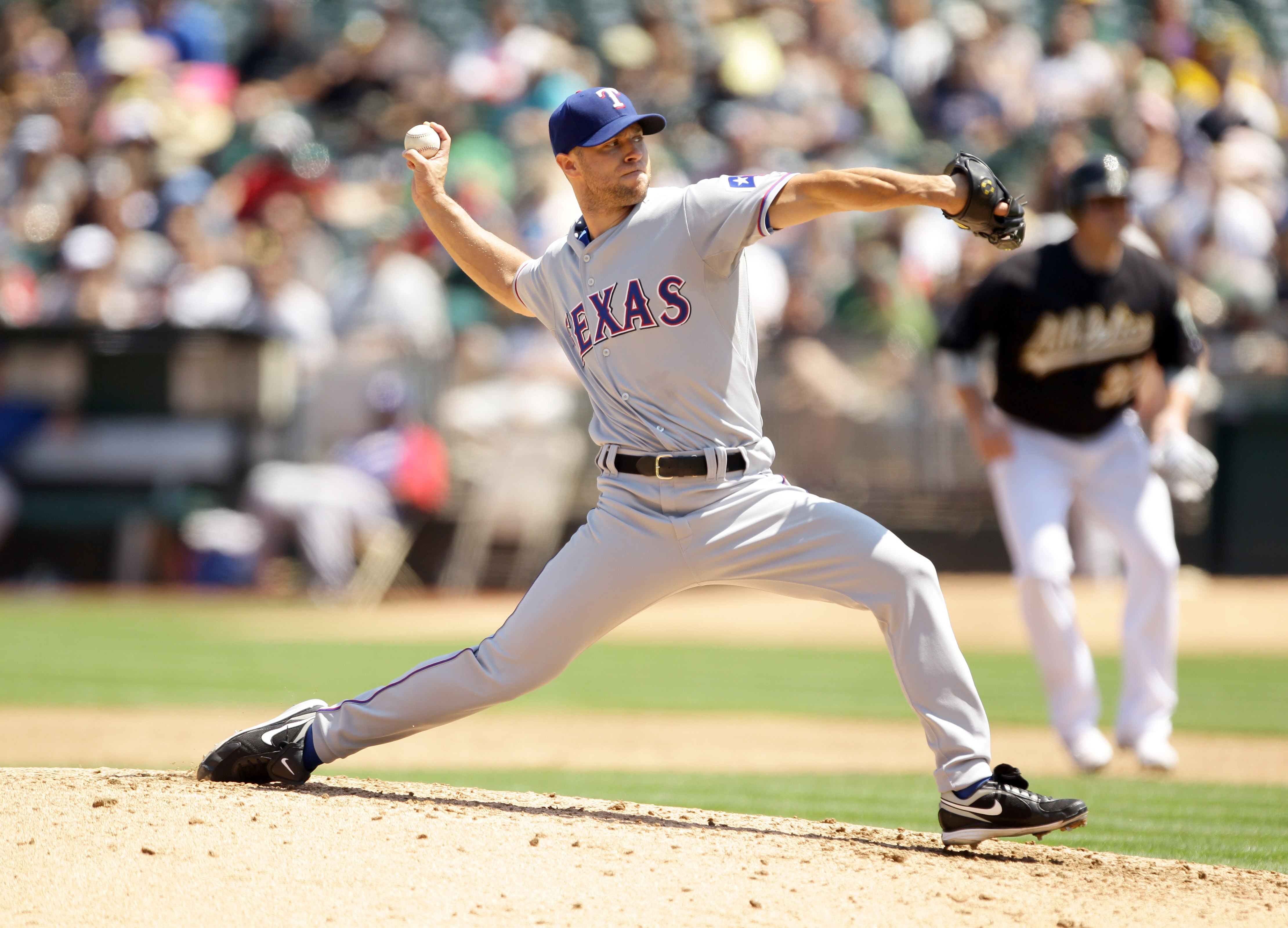 OAKLAND, CA - AUGUST 07:  Rich Harden #40 of the Texas Rangers pitches against the Oakland Athletics at the Oakland-Alameda County Coliseum on August 7, 2010 in Oakland, California.  (Photo by Ezra Shaw/Getty Images)