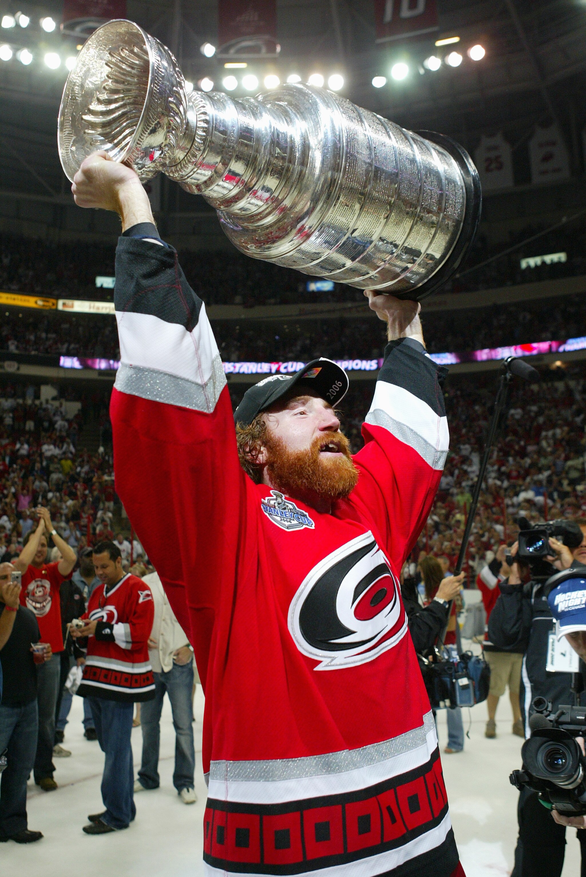 RALEIGH, NC - JUNE 19:  Mike Commodore #22 of the Carolina Hurricanes hoists the Stanley Cup after the Hurricanes defeated the Edmonton Oilers in game seven of the 2006 NHL Stanley Cup Finals on June 19, 2006 at the RBC Center in Raleigh, North Carolina.