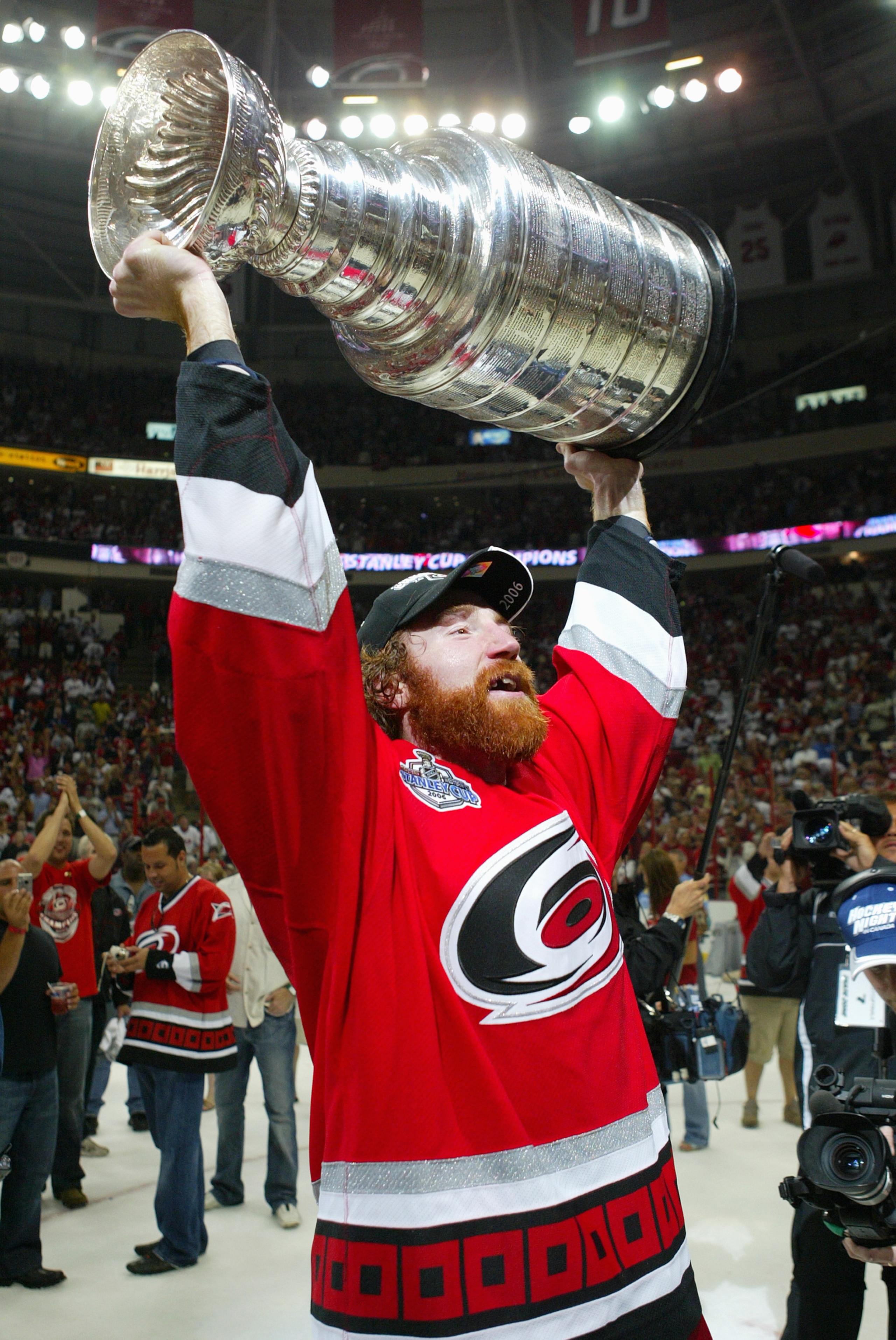 RALEIGH, NC - JUNE 19:  Mike Commodore #22 of the Carolina Hurricanes hoists the Stanley Cup after the Hurricanes defeated the Edmonton Oilers in game seven of the 2006 NHL Stanley Cup Finals on June 19, 2006 at the RBC Center in Raleigh, North Carolina.