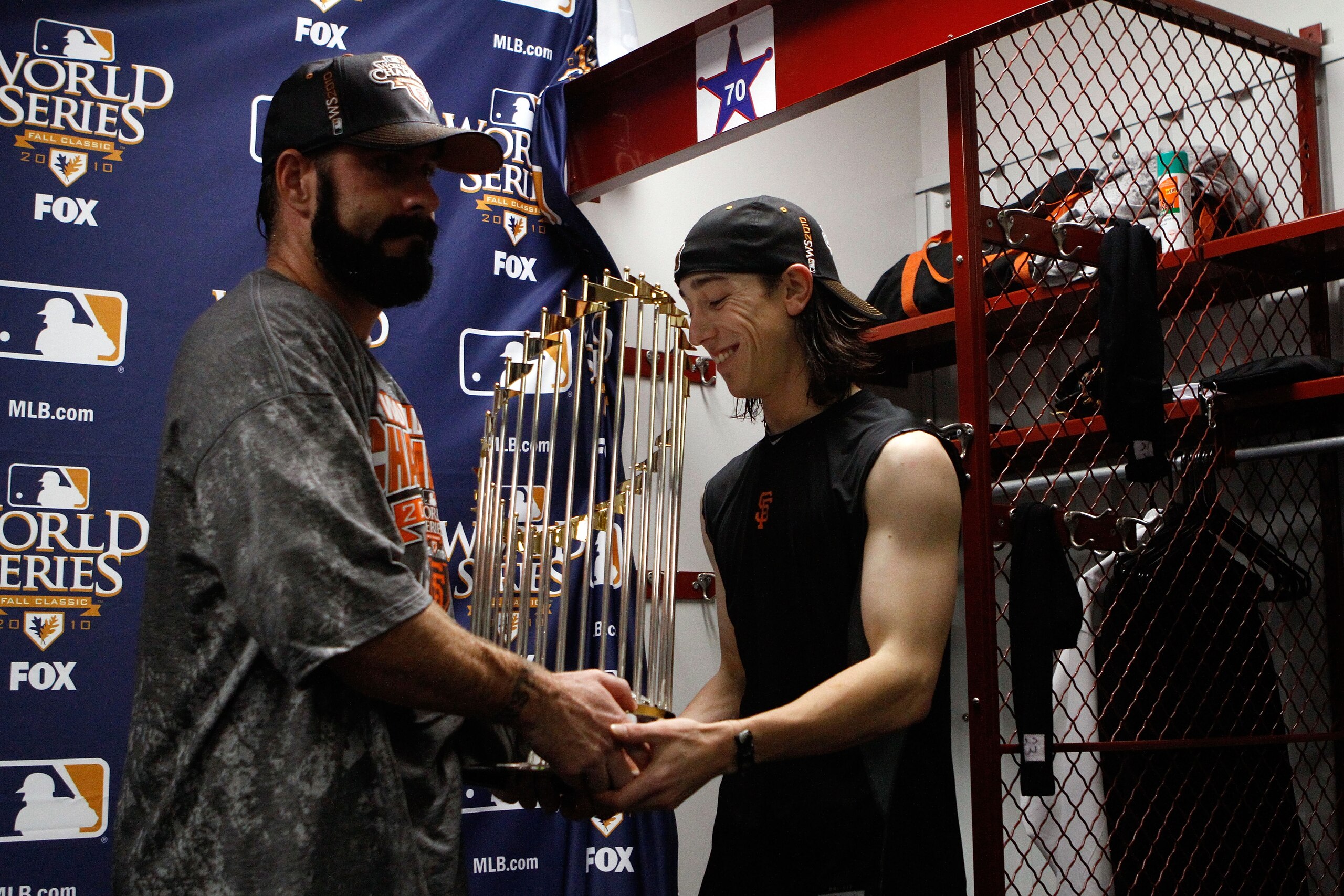 ARLINGTON, TX - NOVEMBER 01:  (L-R) Brian Wilson #28 and Tim Lincecum #55 of the San Francisco Giants celebrate with the World Series trophy in the locker room after the Giants won 3-1 against the Texas Rangers in Game Five of the 2010 MLB World Series at