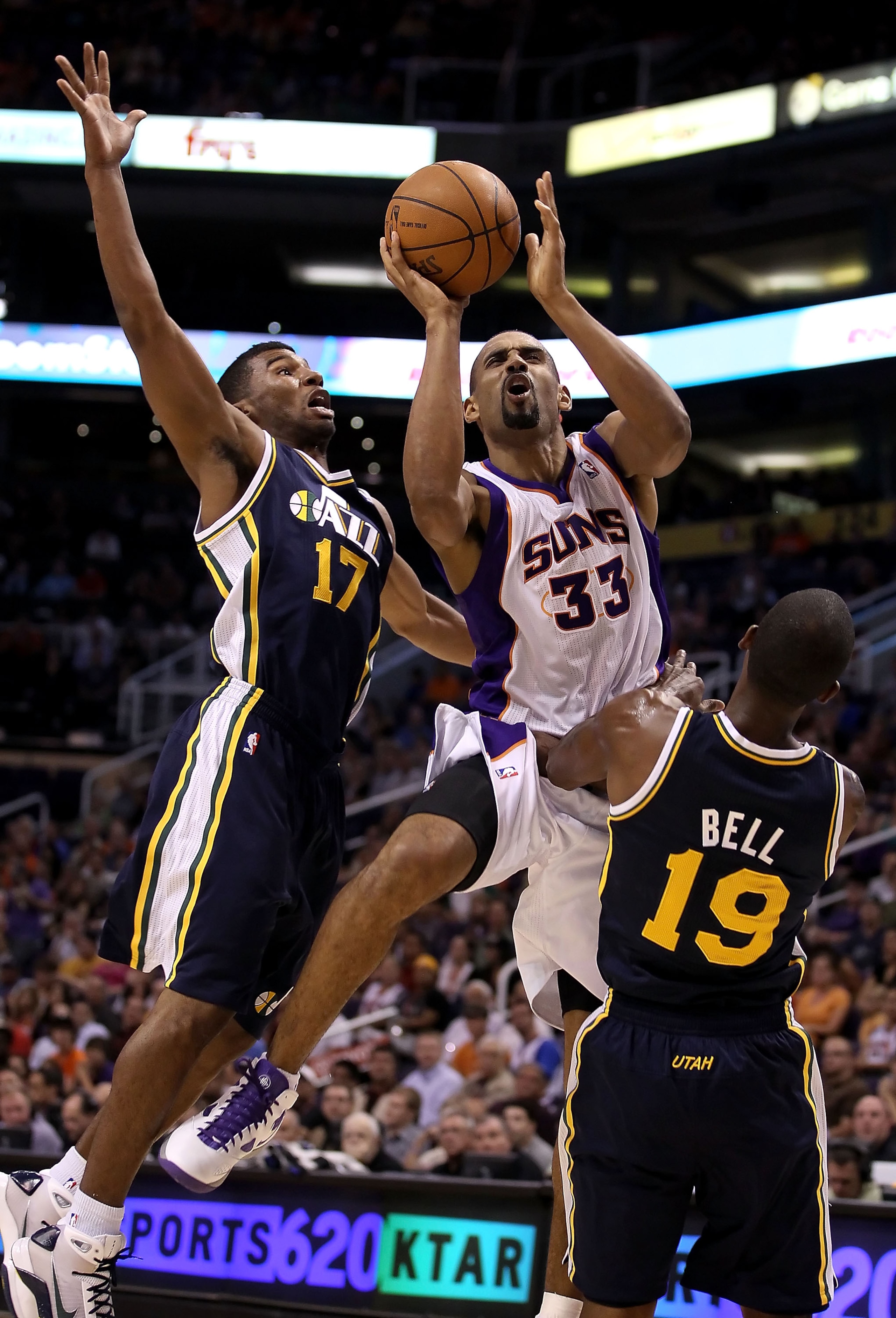 PHOENIX - OCTOBER 12: Grant Hill #33 of the Phoenix Suns attempts a shot under pressure from Ronnie Price #17 and Raja Bell #19 of the Utah Jazz during the preseason NBA game at US Airways Center on October 12, 2010 in Phoenix, Arizona. NOTE TO USER: Use PHOENIX - OCTOBER 12: Grant Hill #33 of the Phoenix Suns attempts a shot under pressure from Ronnie Price #17 and Raja Bell #19 of the Utah Jazz during the preseason NBA game at US Airways Center on October 12, 2010 in Phoenix, Arizona. NOTE TO USER: Use