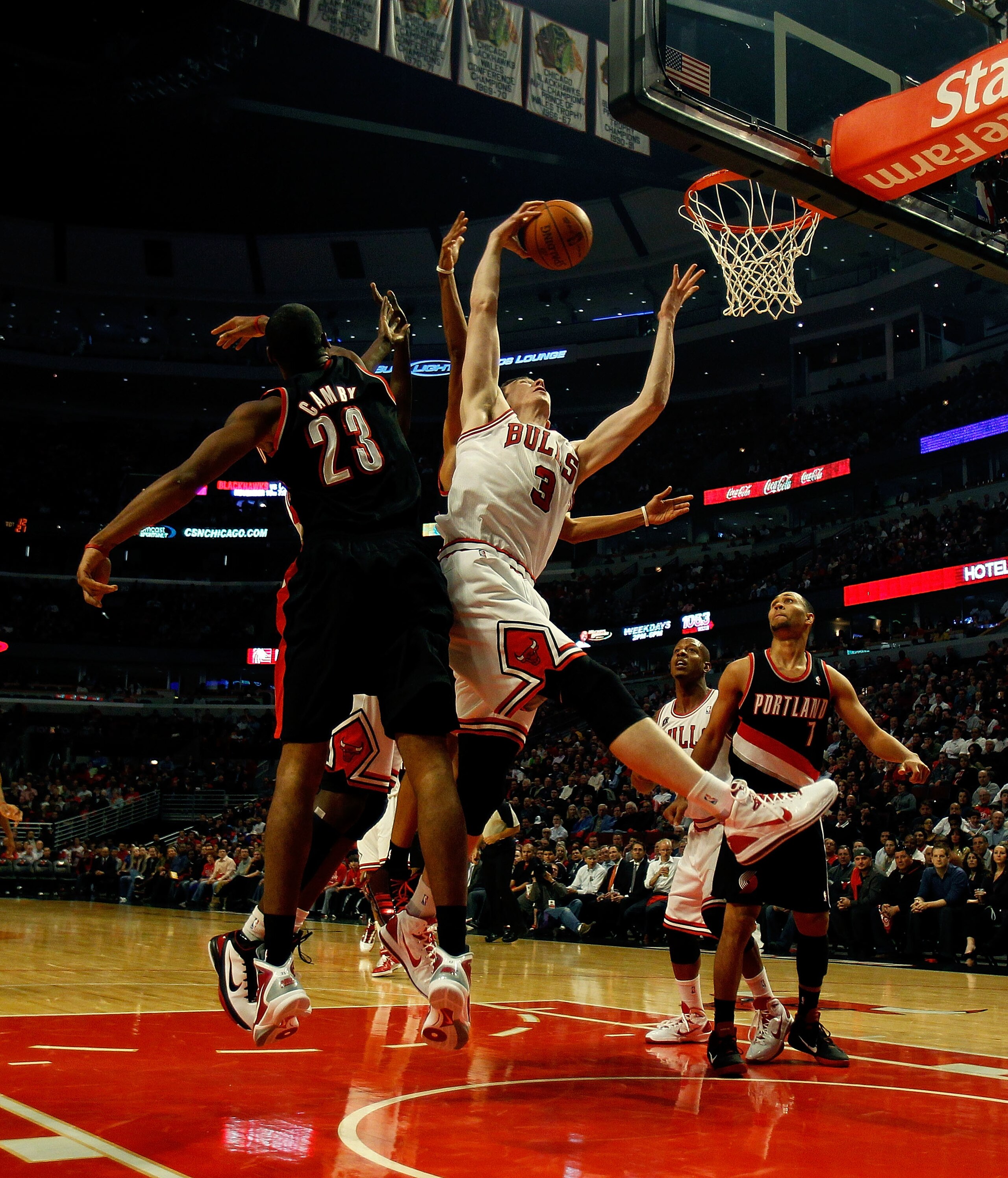 CHICAGO - NOVEMBER 01: Omer Asik #3 of the Chicago Bulls grabs a rebound away from Marcus Camby #23 of the Portland Trail Blazers at the United Center on November 1, 2010 in Chicago, Illinois. The Bulls defeated the Trail Blazers 110-98. NOTE TO USER: Use CHICAGO - NOVEMBER 01: Omer Asik #3 of the Chicago Bulls grabs a rebound away from Marcus Camby #23 of the Portland Trail Blazers at the United Center on November 1, 2010 in Chicago, Illinois. The Bulls defeated the Trail Blazers 110-98. NOTE TO USER: Use