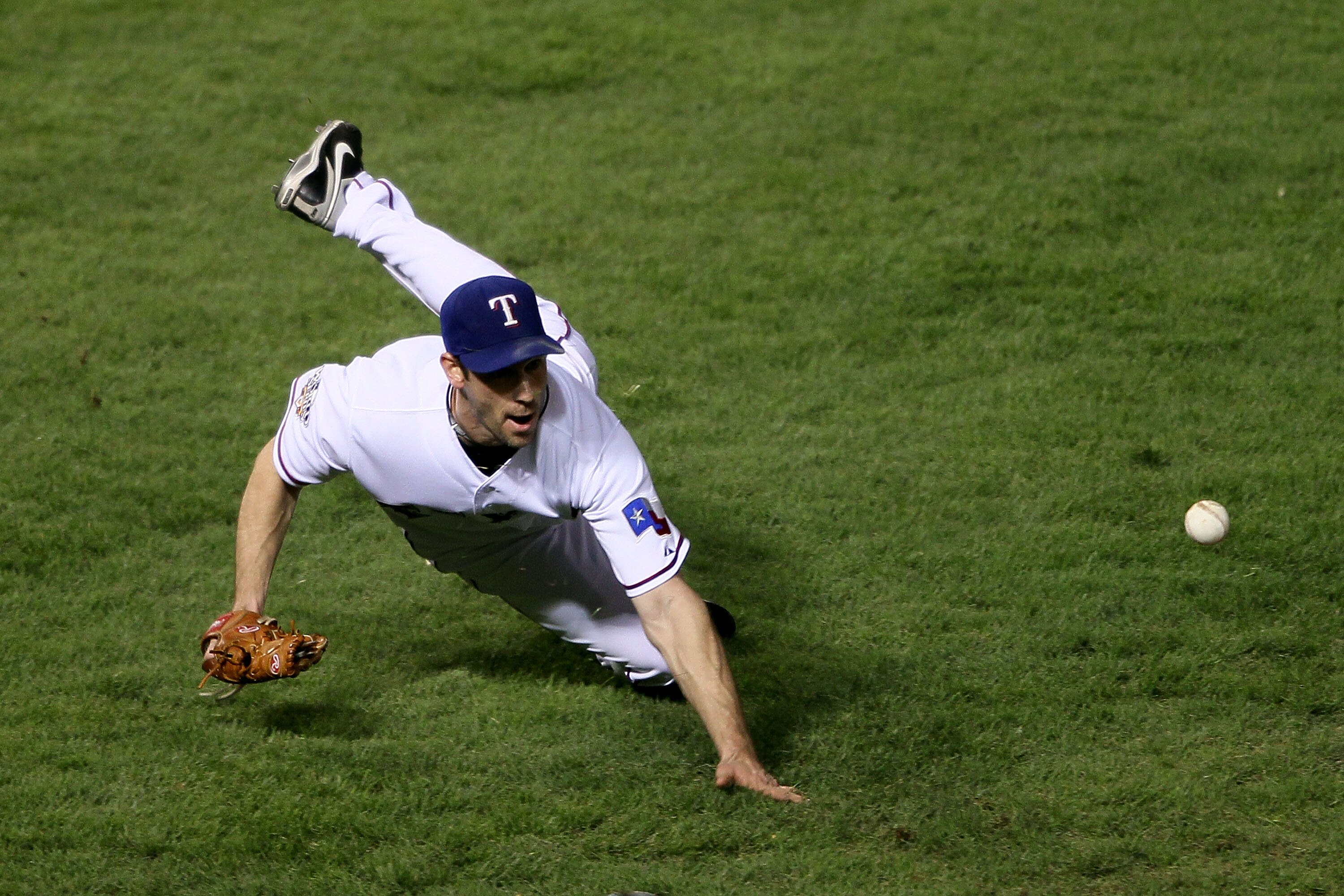 ARLINGTON, TX - NOVEMBER 01:  Cliff Lee #33 of the Texas Rangers tosses over to first for the out after a sac bunt by Aubrey Huff of the San Francisco Giants in Game Five of the 2010 MLB World Series at Rangers Ballpark in Arlington on November 1, 2010 in