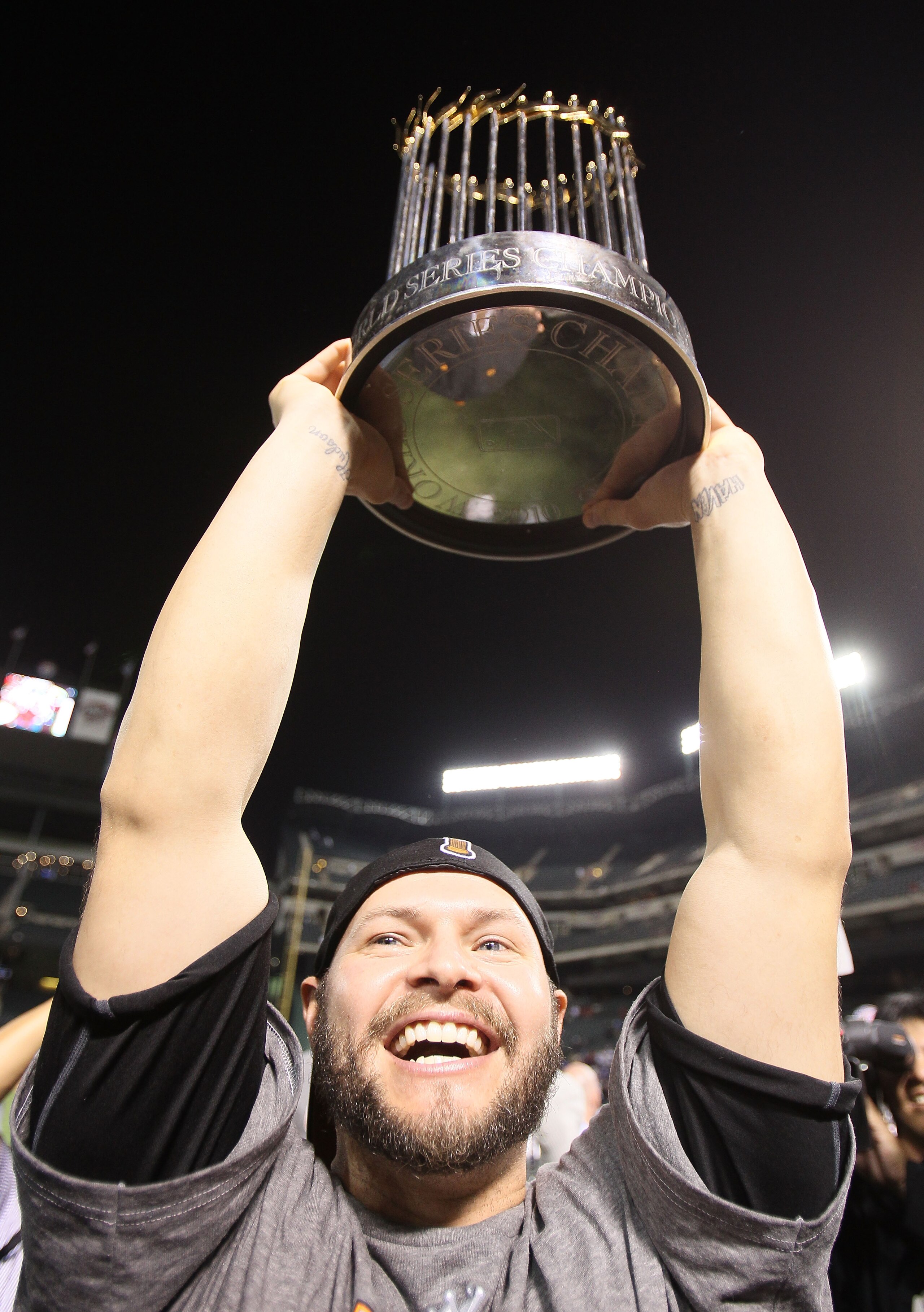 ARLINGTON, TX - NOVEMBER 01:  Cody Ross #13 of the San Francisco Giants celebrates with the World Series Championship trophy after the Giants won 3-1 the Texas Rangers in Game Five of the 2010 MLB World Series at Rangers Ballpark in Arlington on November 