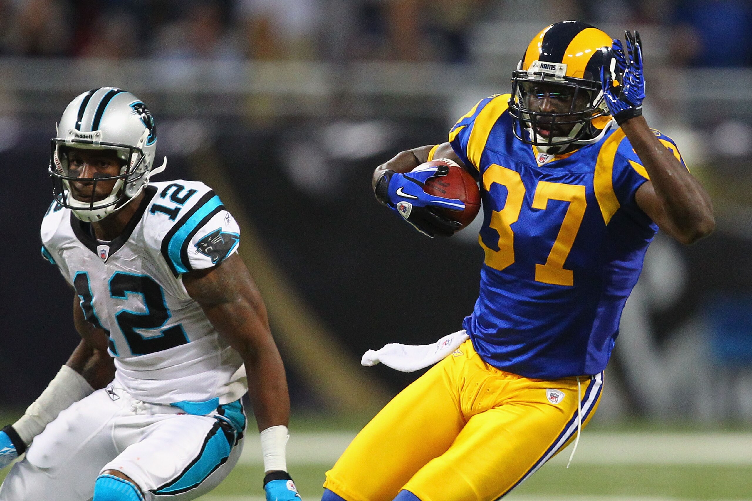 ST. LOUIS - OCTOBER 31: James Butler #37 of the St. Louis Rams returns an interception against David Gettis #12 of the Carolina Panthers at the Edward Jones Dome on October 31, 2010 in St. Louis, Missouri.  The Rams beat the Panthers 20-10.  (Photo by Dil