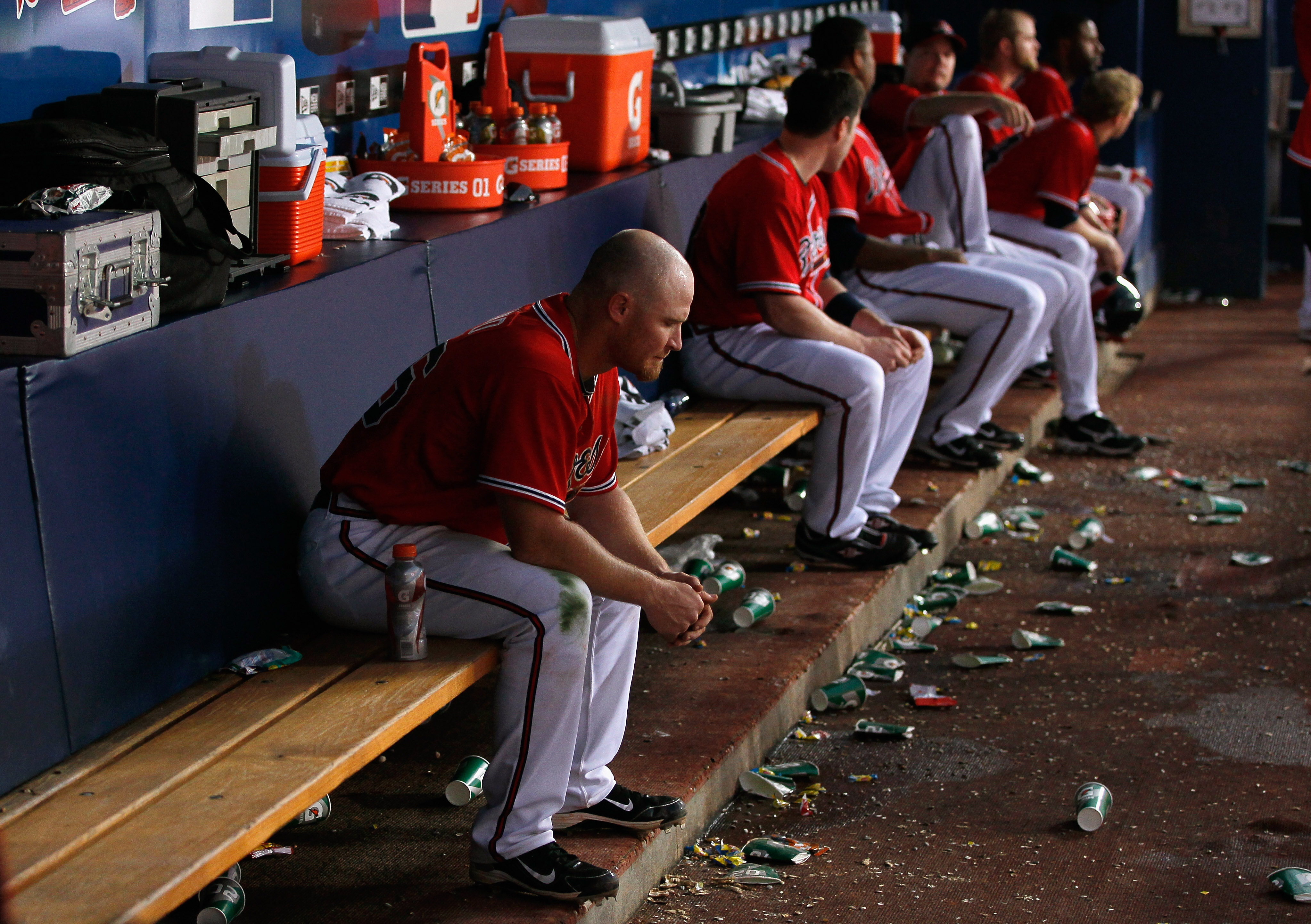 ATLANTA - OCTOBER 10:  Brooks Conrad #26 of the Atlanta Braves sits in the dugout in the eighth inning after pop-flying a bunt for an out against the San Francisco Giants during Game Three of the NLDS of the 2010 MLB Playoffs at Turner Field on October 10