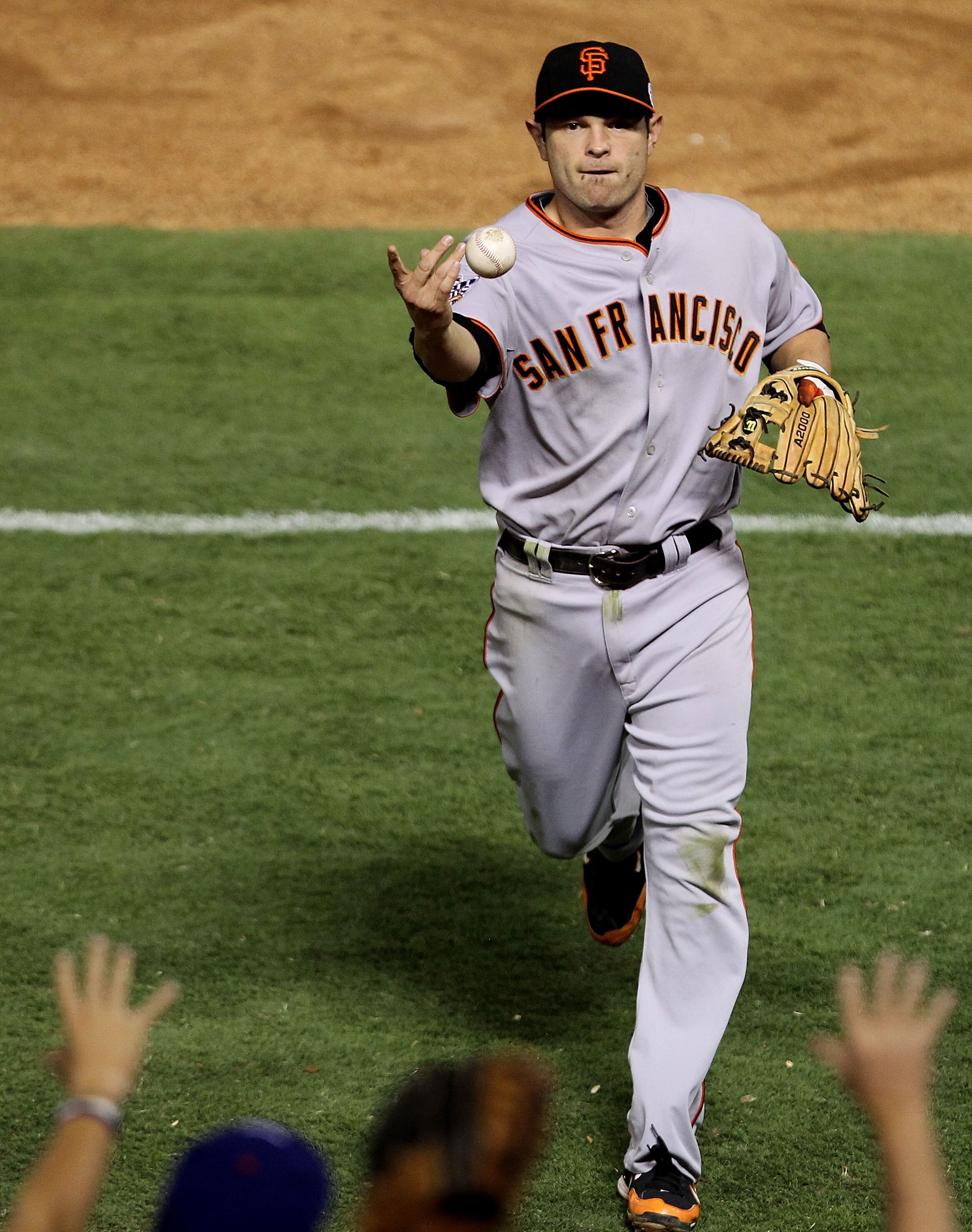ARLINGTON, TX - OCTOBER 31:  Freddy Sanchez #21 the San Francisco Giants tosses a ball to the crowd during Game Four of the 2010 MLB World Series against the Texas Rangers at Rangers Ballpark in Arlington on October 31, 2010 in Arlington, Texas.  (Photo b