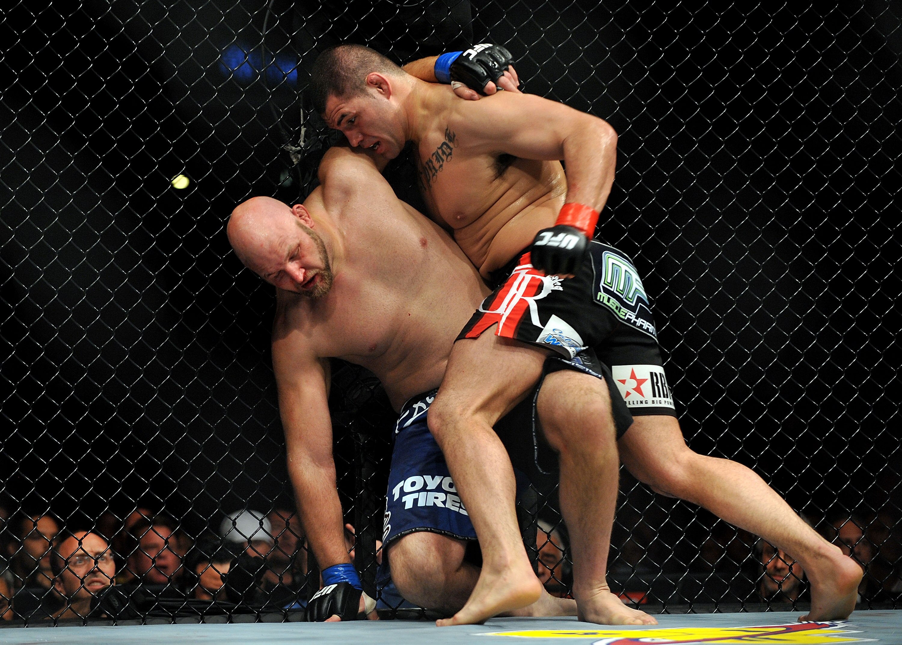 LOS ANGELES, CA - OCTOBER 24:  UFC fighter Cain Velasquez (R) hits UFC fighter Ben Rothwell (L) up against the fence during their Heavyweight bout at UFC 104: Machida vs. Shogun at Staples Center on October 24, 2009 in Los Angeles, California.  Velasquez