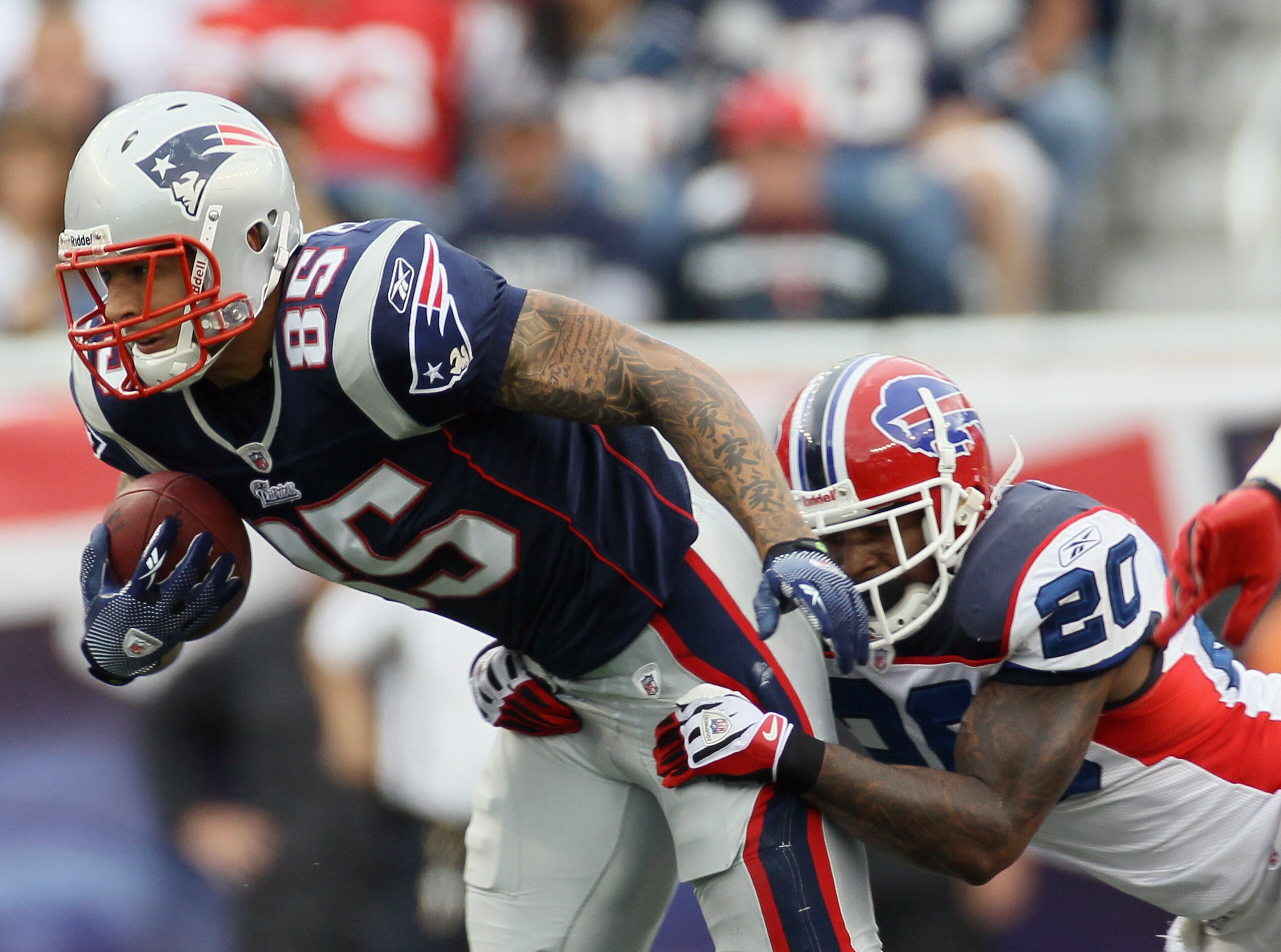 FOXBORO, MA - SEPTEMBER 26:  Aaron Hernandez #85 of the New England Patriots is brought down by Donte Whitner #20 of the Buffalo Bills during on September 26, 2010 at Gillette Stadium in Foxboro, Massachusetts. The Patriots defeated the Bills 38-30.  (Pho