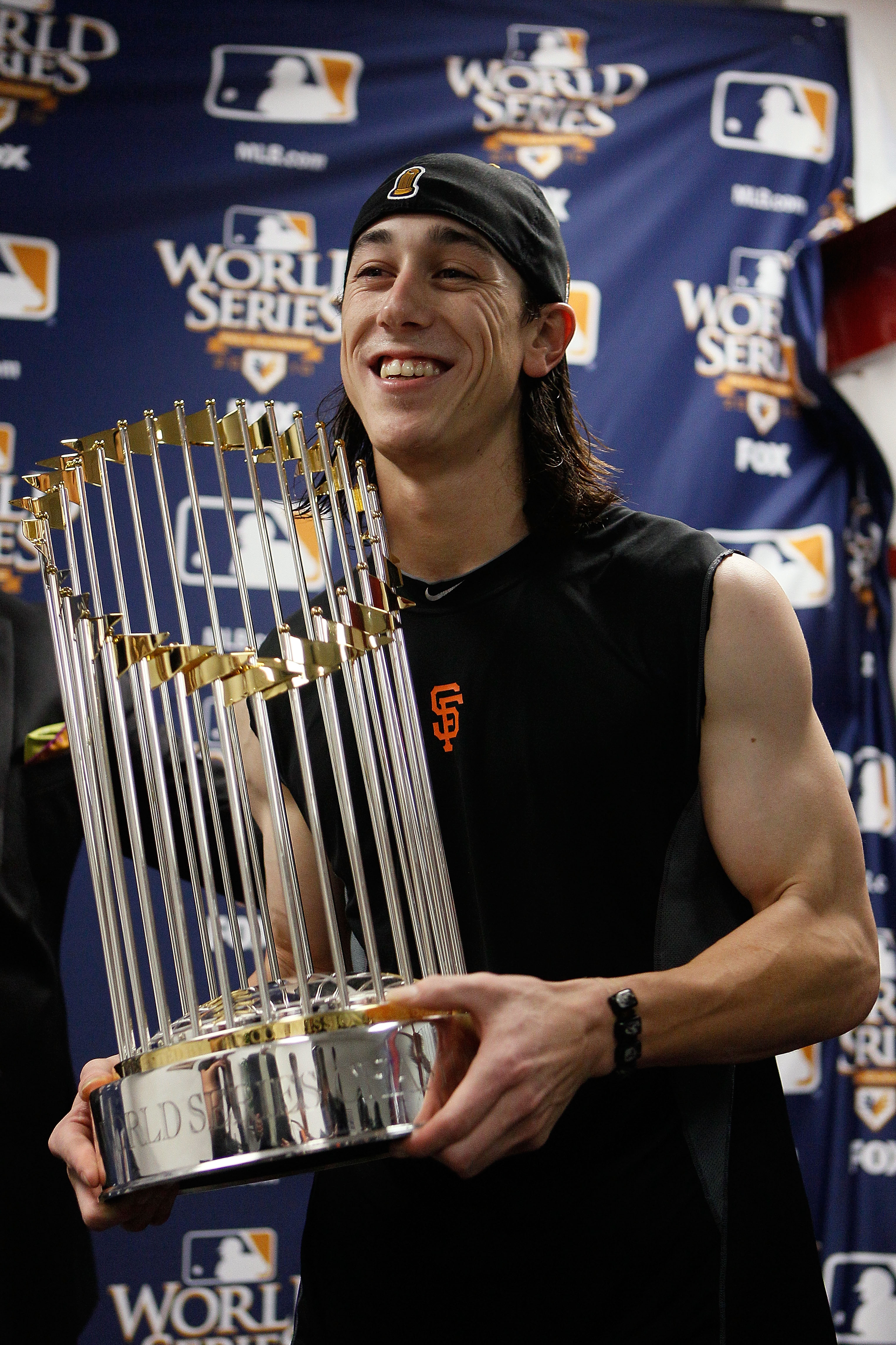 ARLINGTON, TX - NOVEMBER 01:  Tim Lincecum #55 of the San Francisco Giants celebrates with the World Series trophy in the locker room after the Giants won 3-1 against the Texas Rangers in Game Five of the 2010 MLB World Series at Rangers Ballpark in Arlin