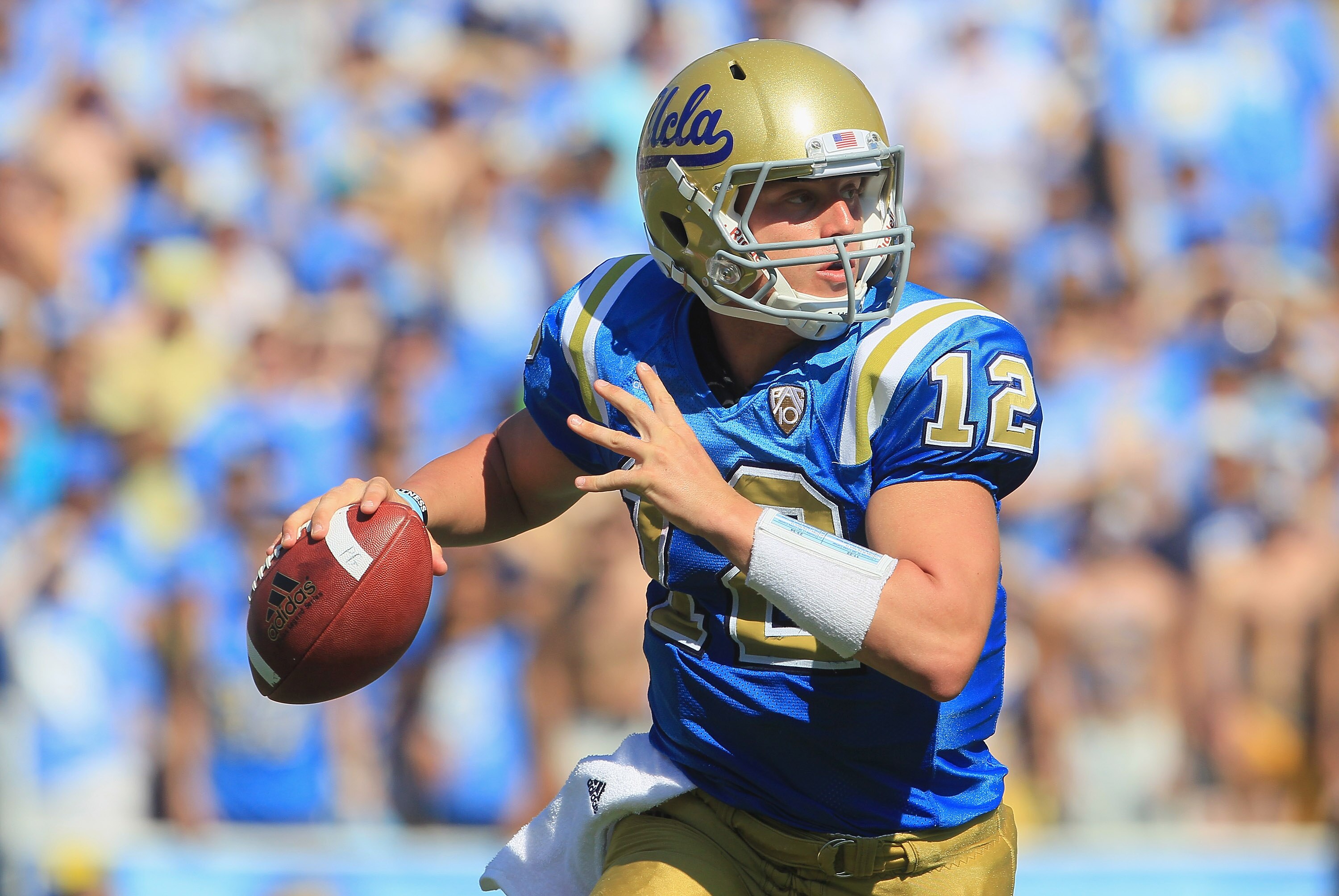 PASADENA, CA - OCTOBER 02:  Quarterback Richard Brehaut #12 of the UCLA Bruins looks down field for an open receiver against the Washington State Cougars during the third quarter at the Rose Bowl on October 2, 2010 in Pasadena, California. UCLA defeated W
