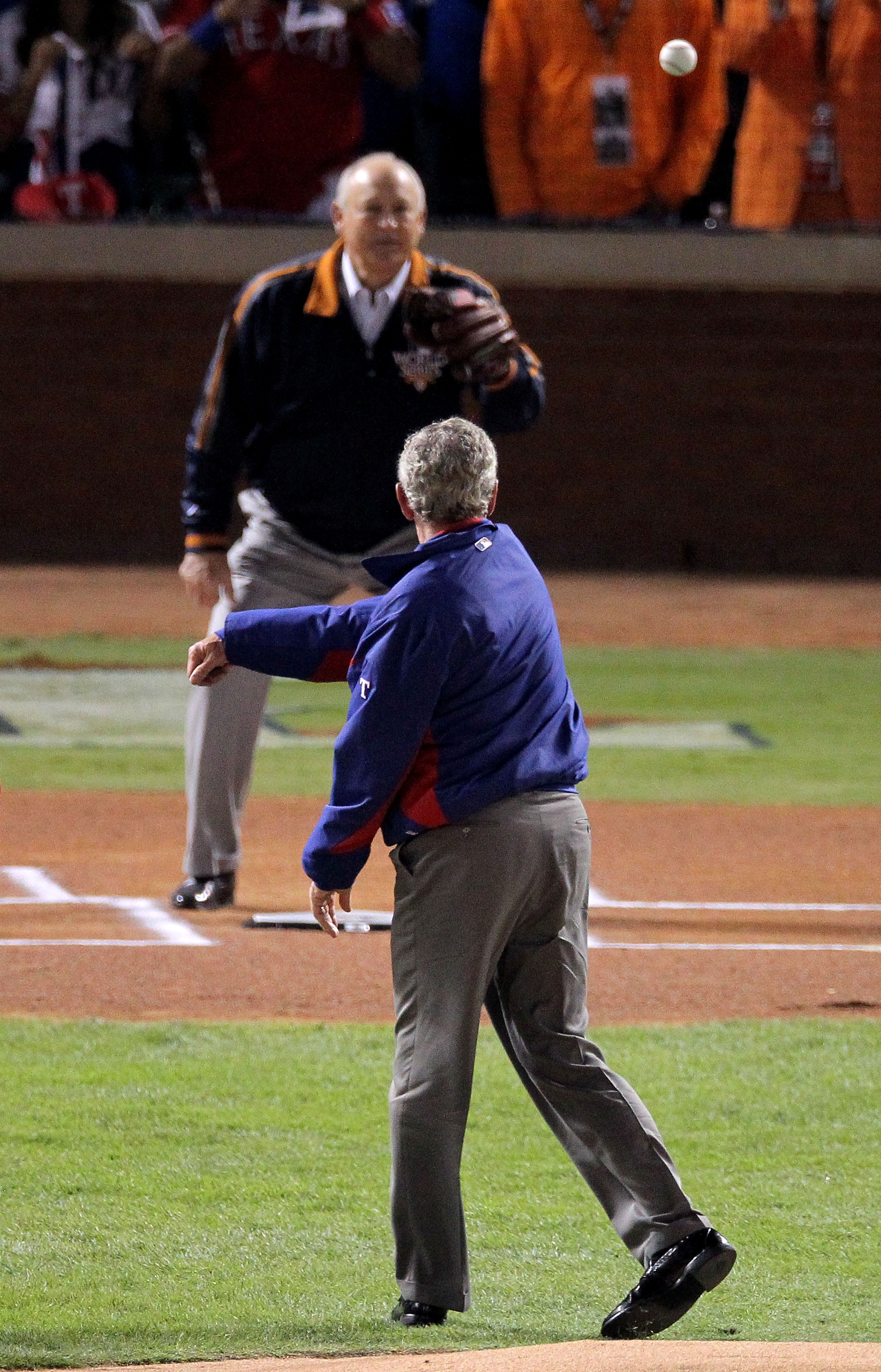 ARLINGTON, TX - OCTOBER 31:  Former President of the United States, George W. Bush, throws out the ceremonial first pitch to former MLB pitcher, Nolan Ryan, before the Texas Rangers host the San Francisco Giants in  in Game Four of the 2010 MLB World Seri