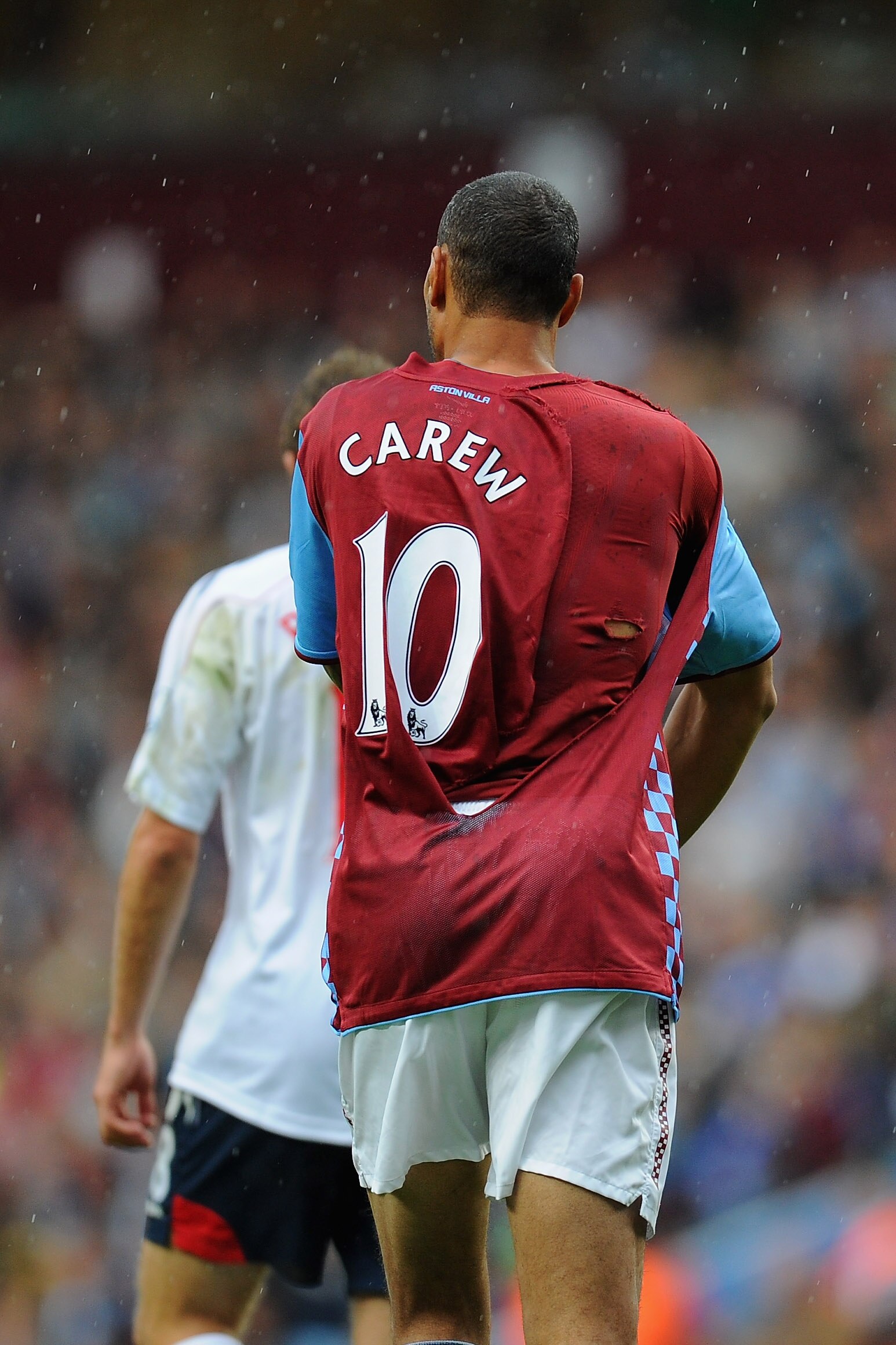 BIRMINGHAM, ENGLAND - SEPTEMBER 18:  John Carew of Aston Villa wears a torn shirt during the Barclays Premier League match between Aston villa and Bolton Wanderers at Villa Park on September 18, 2010 in Birmingham, England.  (Photo by Clive Mason/Getty Im