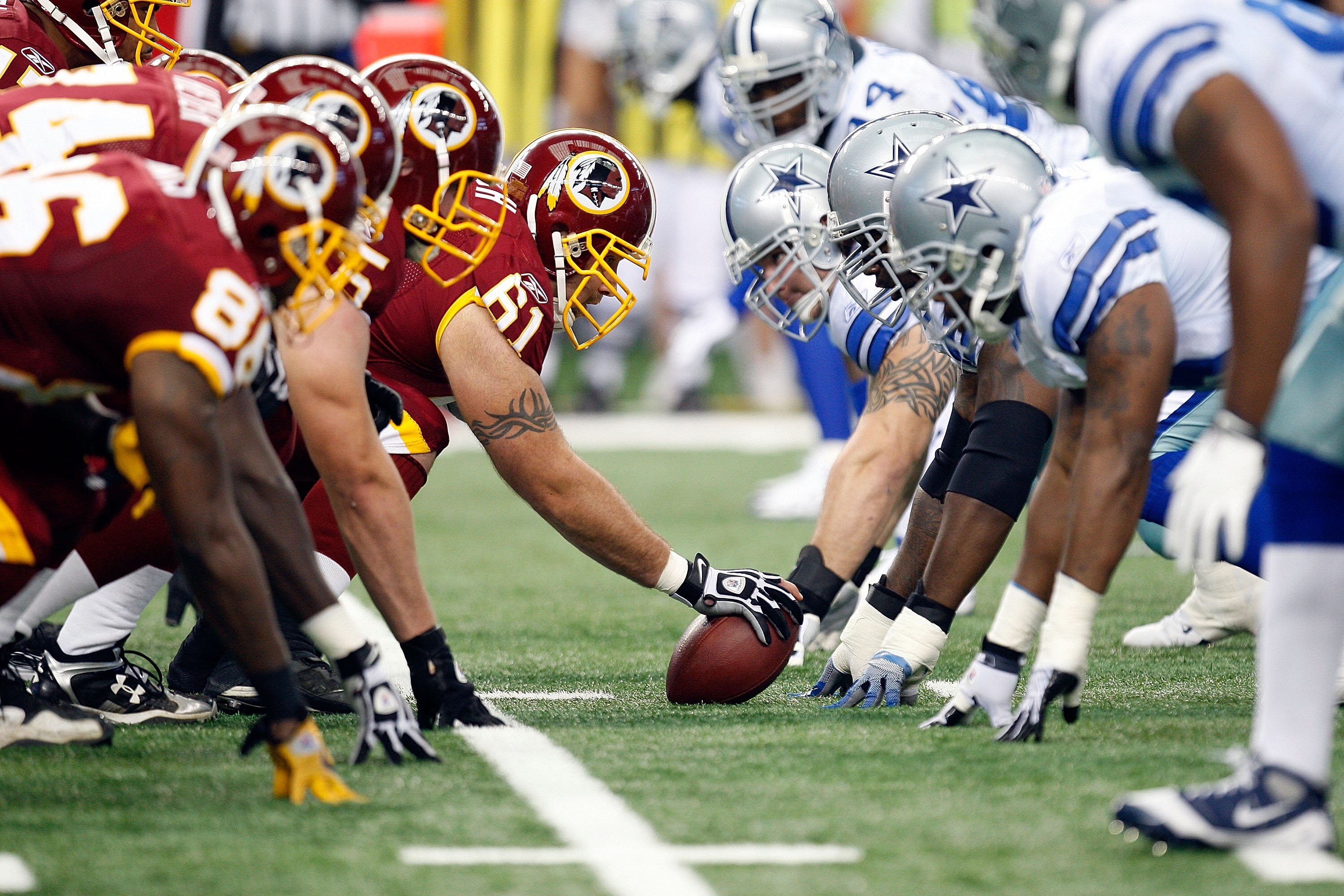 ARLINGTON, TX - NOVEMBER 22:  The Washington Redskins offensive line prepares to snap the ball against the Dallas Cowboys at Cowboys Stadium on November 22, 2009 in Arlington, Texas.  (Photo by Ronald Martinez/Getty Images)