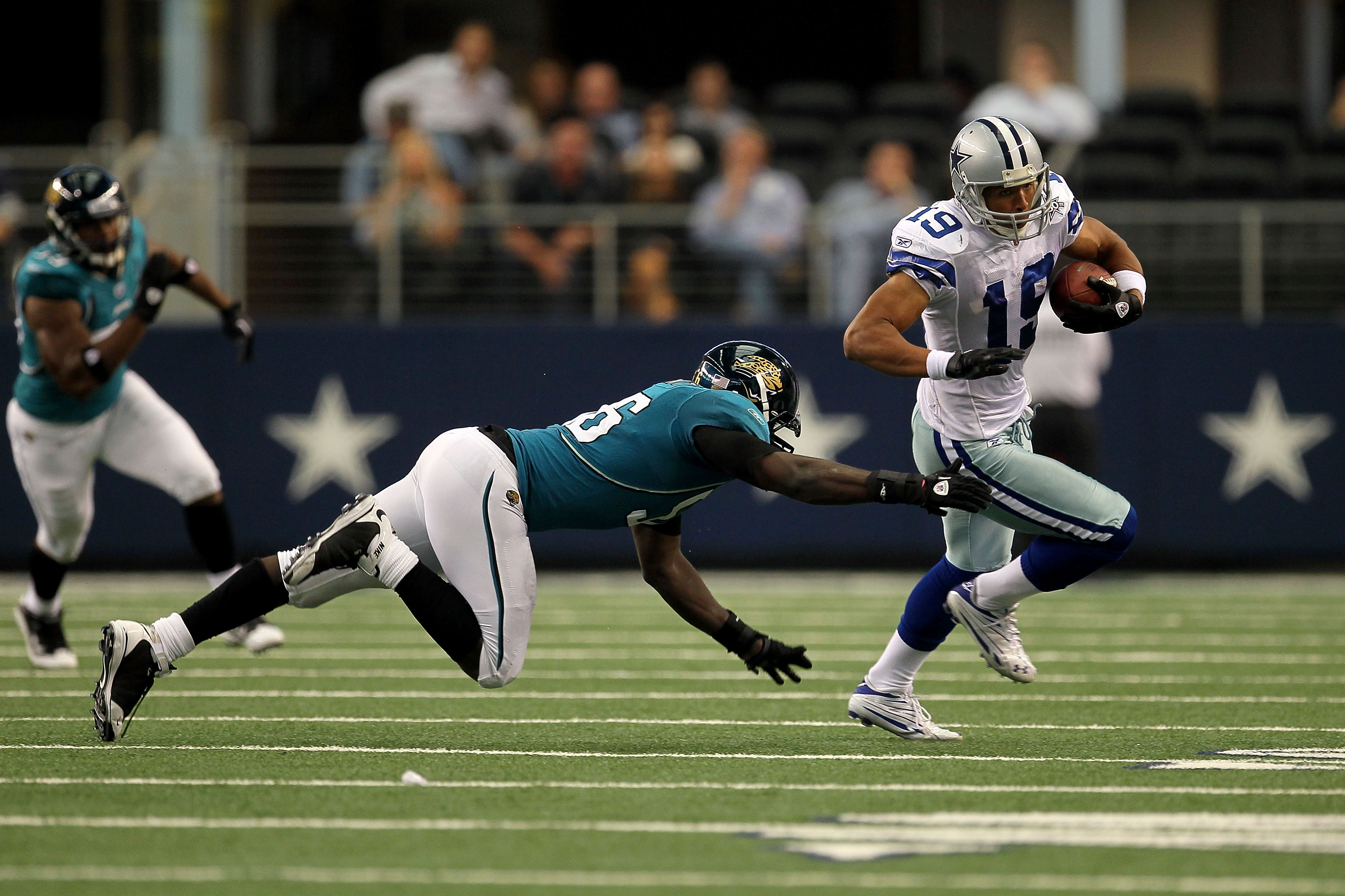 ARLINGTON, TX - OCTOBER 31:  Miles Austin #19 of the Dallas Cowboys runs for yards after the catch in the first half against Justin Durant #56 of the Jacksonville Jaguars at Cowboys Stadium on October 31, 2010 in Arlington, Texas.  (Photo by Stephen Dunn/