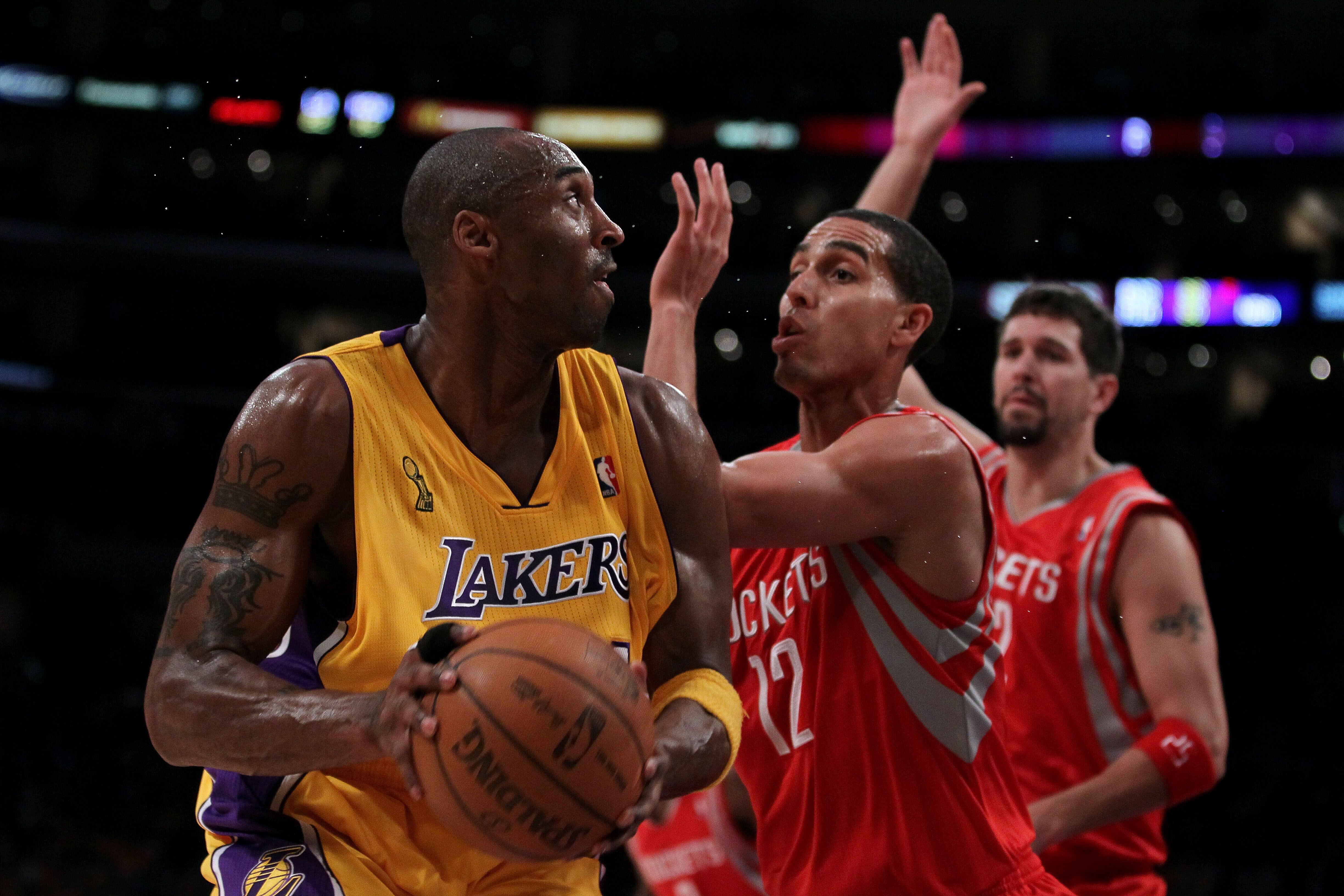 LOS ANGELES, CA - OCTOBER 26:  Kobe Bryant #24 of the Los Angeles Lakers looks to move the ball against Kevin Martin #12 of the Houston Rockets during their opening night game at Staples Center on October 26, 2010 in Los Angeles, California. NOTE TO USER: