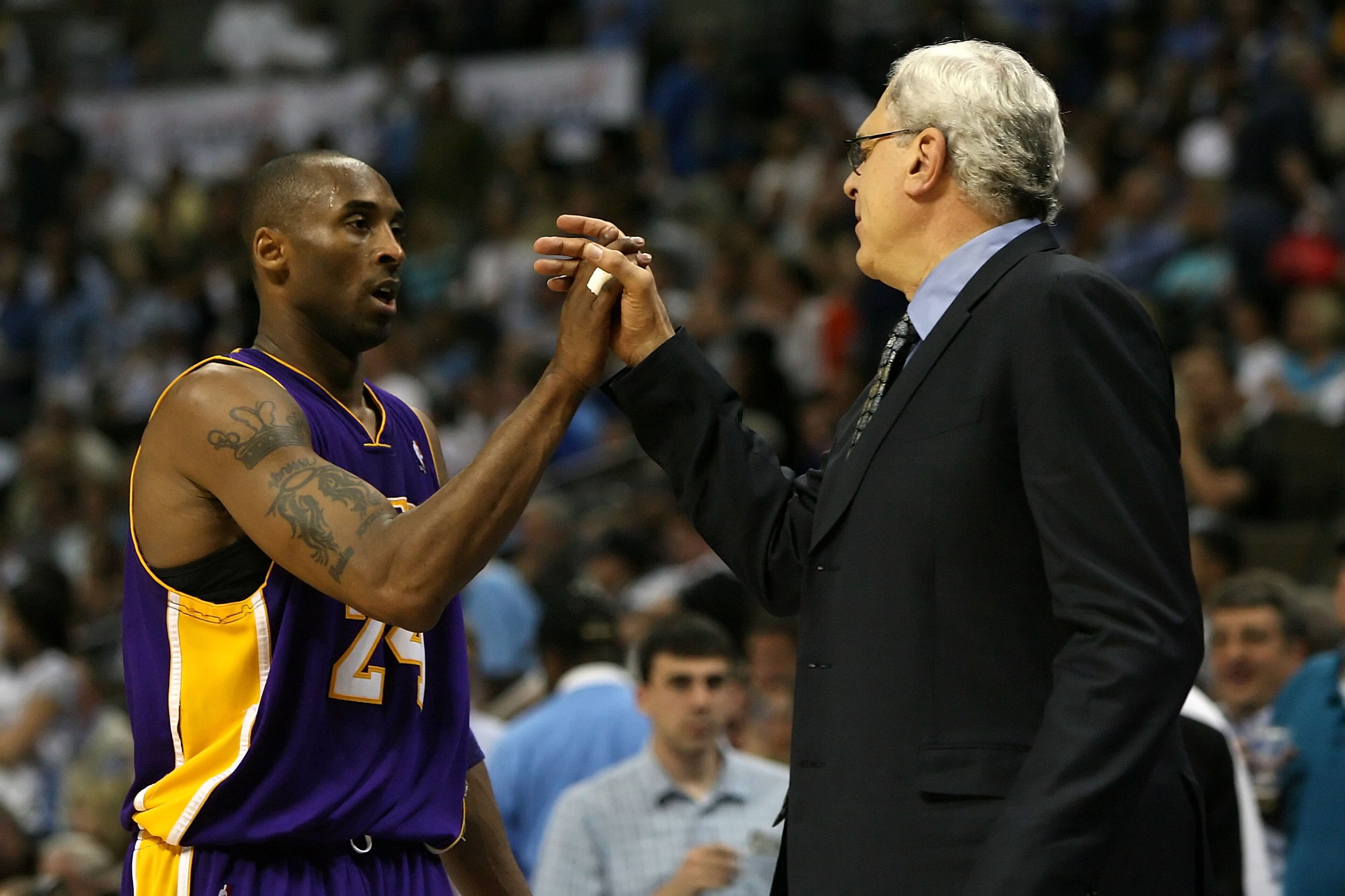 DENVER - MAY 29: (L-R) Kobe Bryant #24 of the Los Angeles Lakers shakes hands with head coach Phil Jackson as Bryant is taken out of the game in the fourth quarter against the Denver Nuggets in Game Six of the Western Conference Finals during the 2009 NB DENVER - MAY 29: (L-R) Kobe Bryant #24 of the Los Angeles Lakers shakes hands with head coach Phil Jackson as Bryant is taken out of the game in the fourth quarter against the Denver Nuggets in Game Six of the Western Conference Finals during the 2009 NB