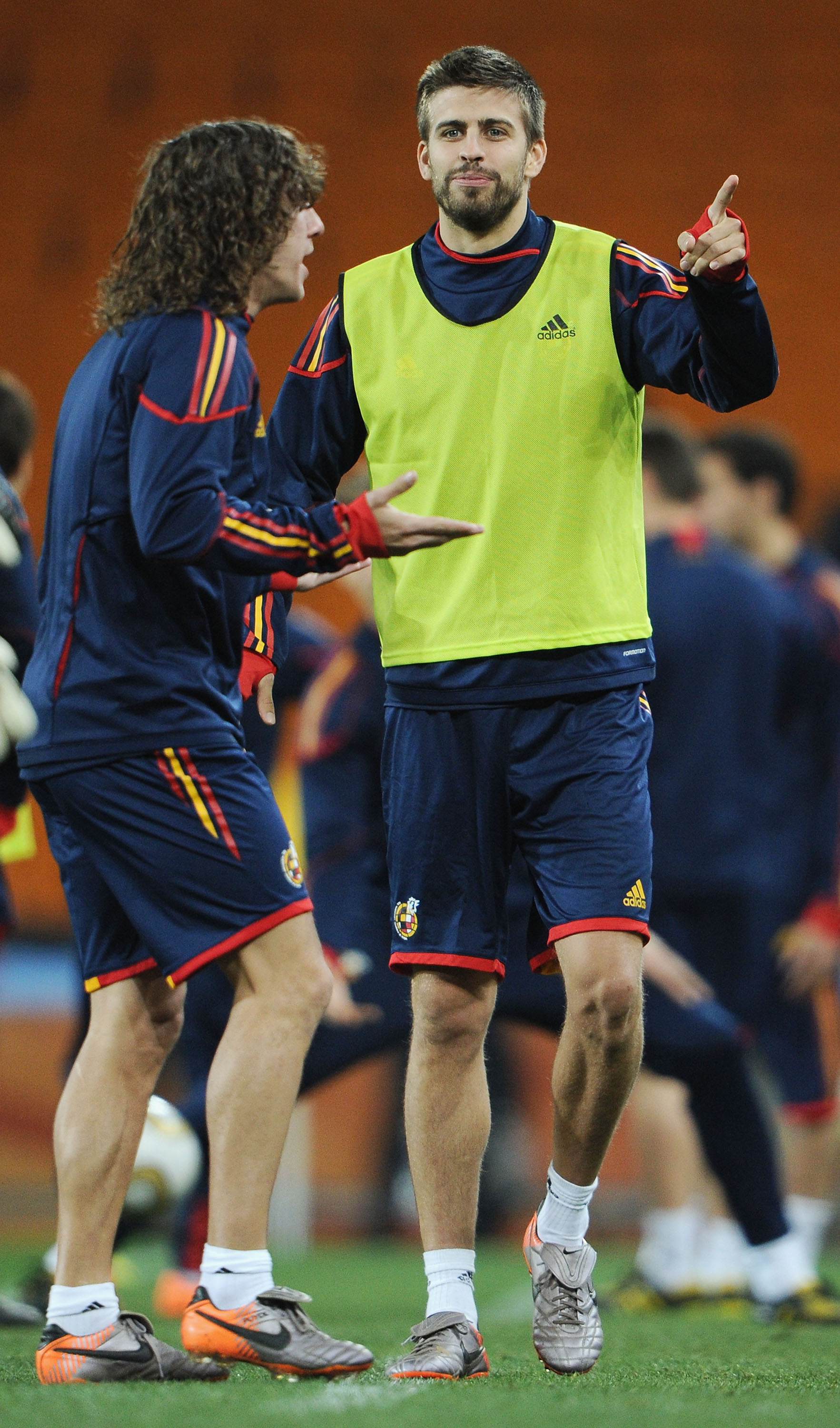 JOHANNESBURG, SOUTH AFRICA - JULY 10:  Gerard Pique of Spain chats with Carlos Puyol (L) during a Spain training session, ahead of the 2010 FIFA World Cup Final, at Soccer City Stadium on July 10, 2010 in Johannesburg, South Africa.  (Photo by Jasper Juin