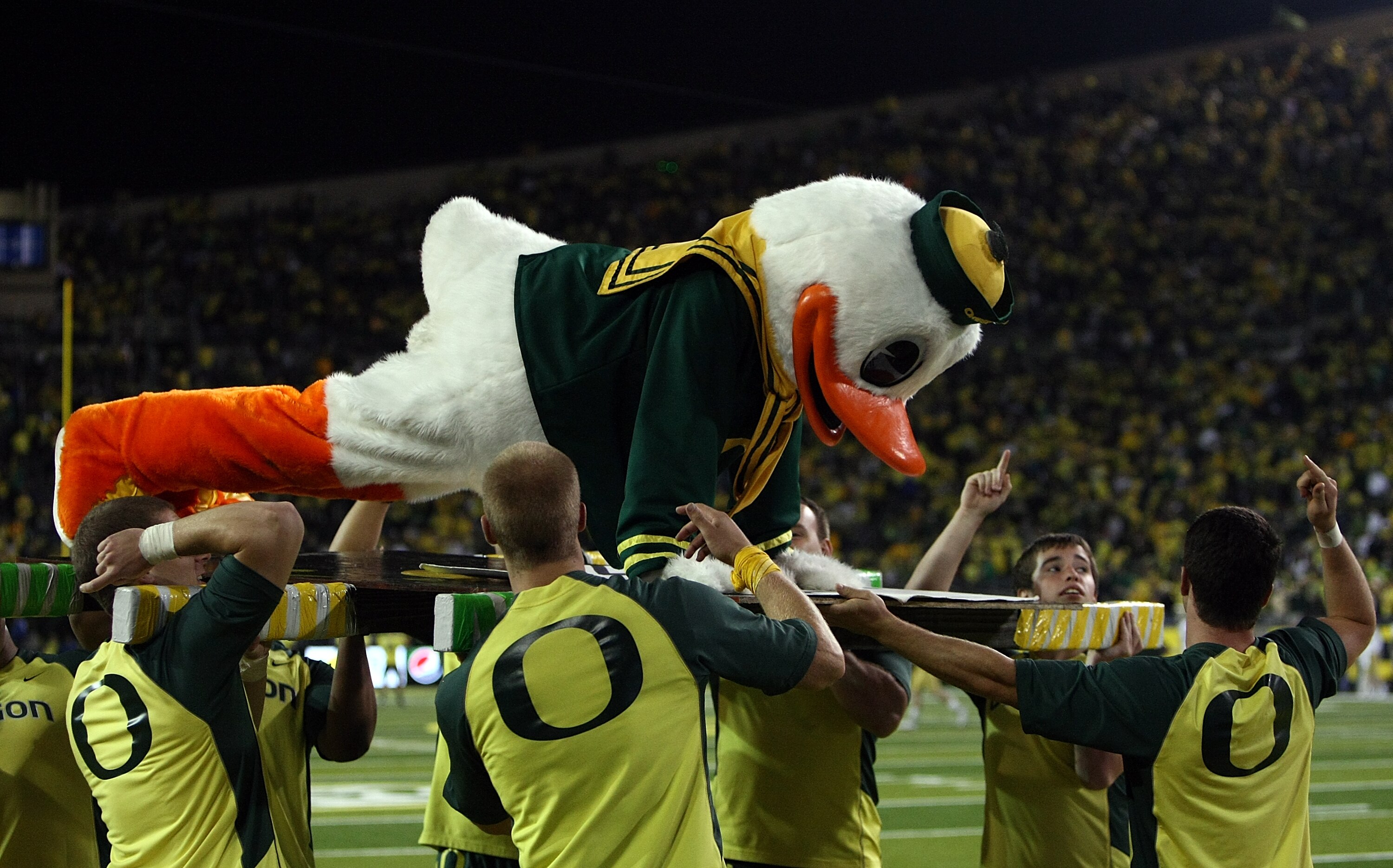 EUGENE, OR - OCTOBER 21:  The Oregon Duck mascot does push ups after a touchdown against the UCLA Bruins  on October 21, 2010 at the Autzen Stadium in Eugene, Oregon.  (Photo by Jonathan Ferrey/Getty Images)