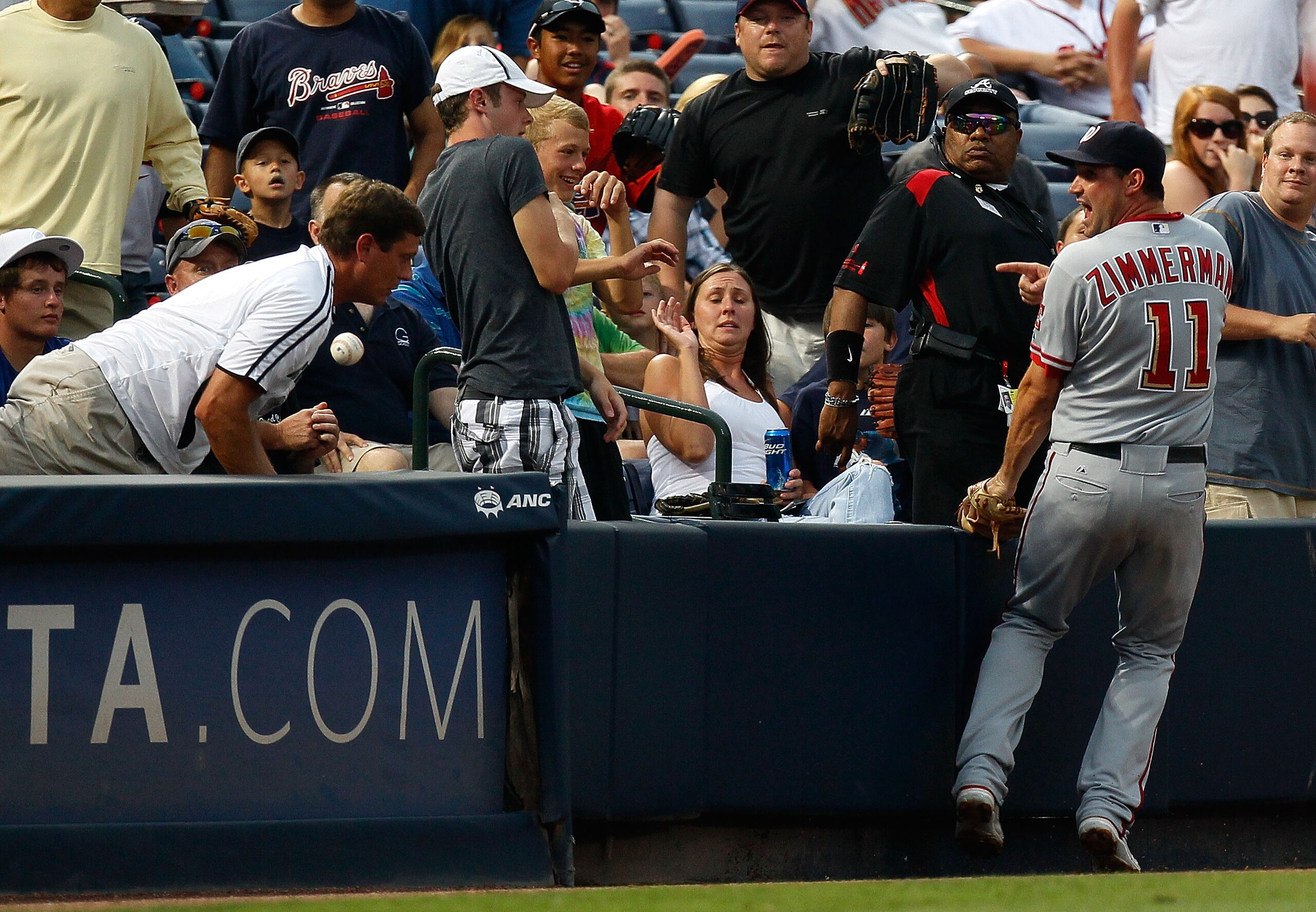 ATLANTA - JUNE 30:  Third baseman Ryan Zimmerman #11 of the Washington Nationals reacts after a fan interfered with a foul ball during the game against the Atlanta Braves at Turner Field on June 30, 2010 in Atlanta, Georgia.  (Photo by Kevin C. Cox/Getty