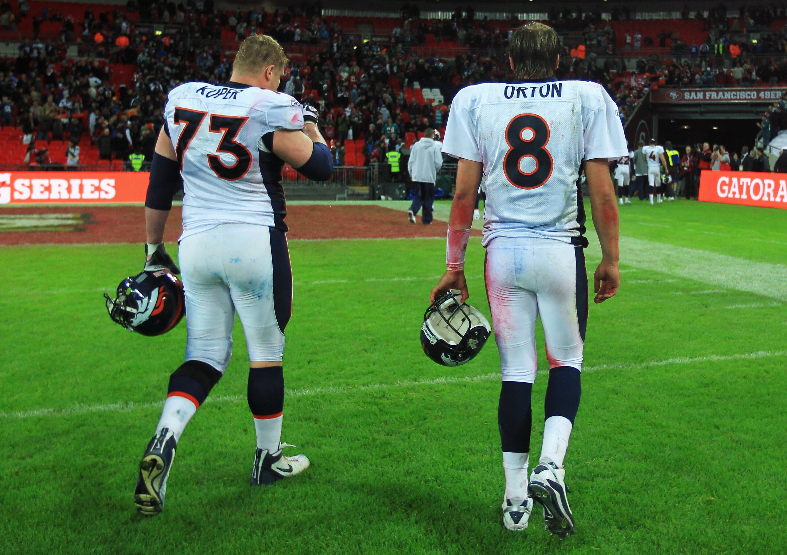 LONDON, ENGLAND - OCTOBER 31:  Quarterback Kyle Orton #8 of Denver Broncos and Chris Kuper #73 of Denver Broncos leave the feel dejected in defeat after the NFL International Series match between Denver Broncos and San Francisco 49ers at Wembley Stadium o