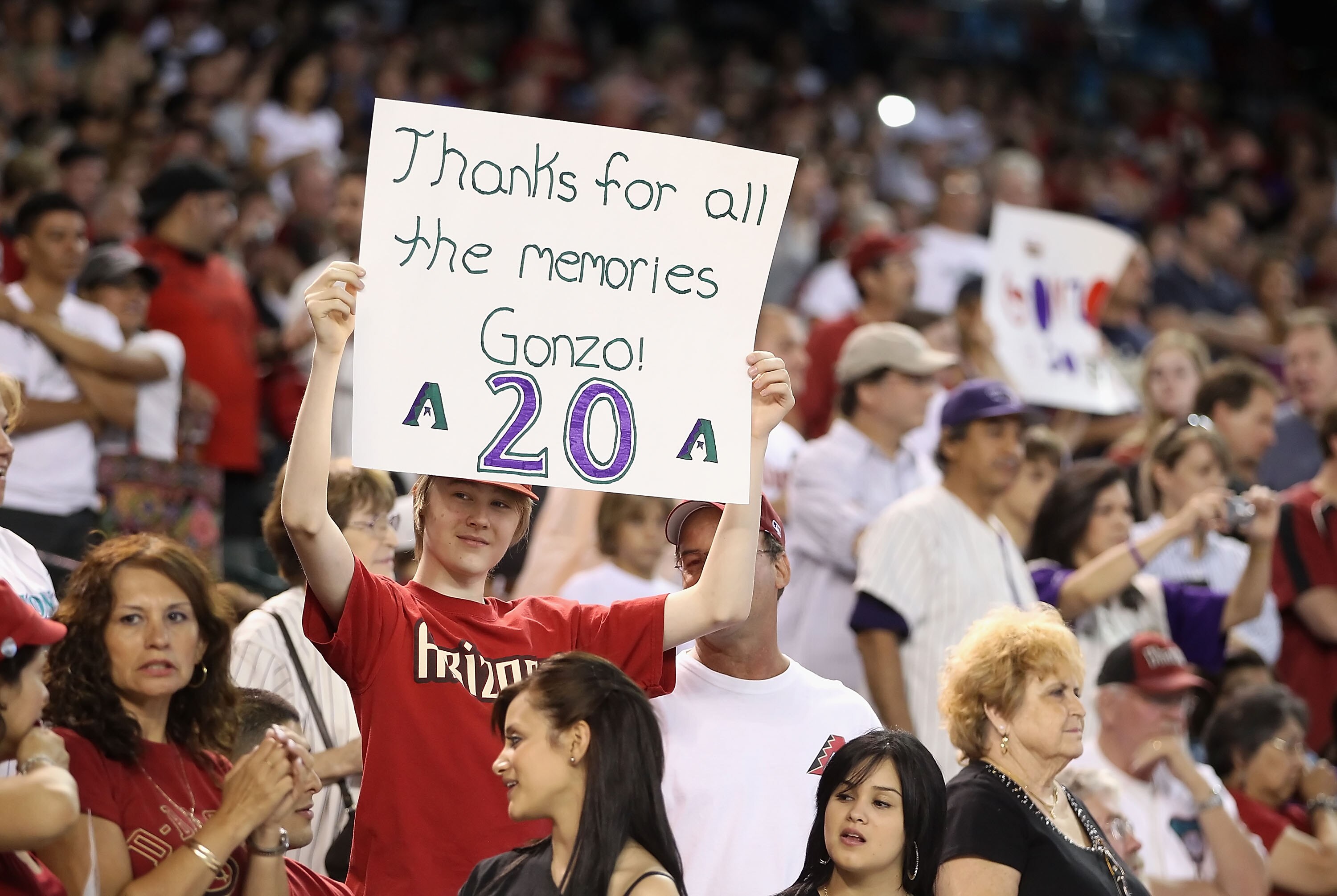 PHOENIX - AUGUST 07:  Fans hold signs in honor of Luis Gonzalez getting his number retired before the Major League Baseball game between the San Diego Padres and the Arizona Diamondbacks at Chase Field on August 7, 2010 in Phoenix, Arizona.  (Photo by Chr