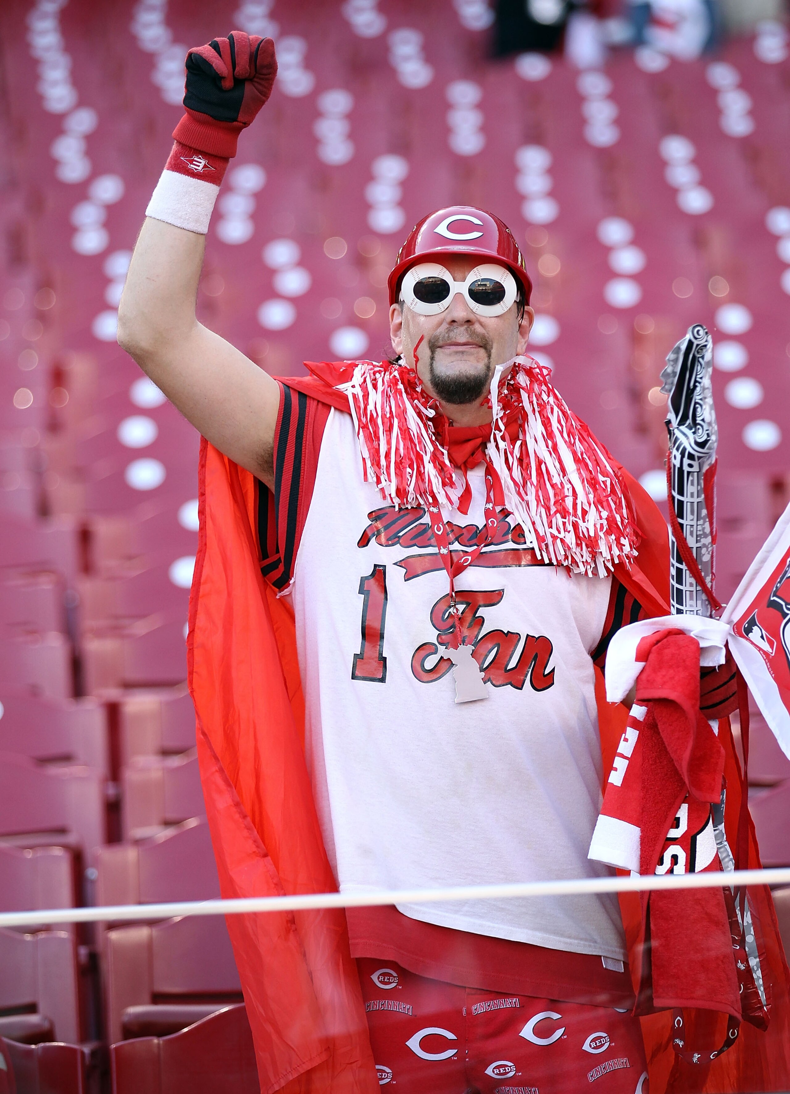 CINCINNATI - OCTOBER 10:  A Cincinnati Reds fan watches batting practice before the start of  Game 3 of the NLDS against the Philadelphia Phillies at Great American Ball Park on October 10, 2010 in Cincinnati, Ohio.  (Photo by Andy Lyons/Getty Images)