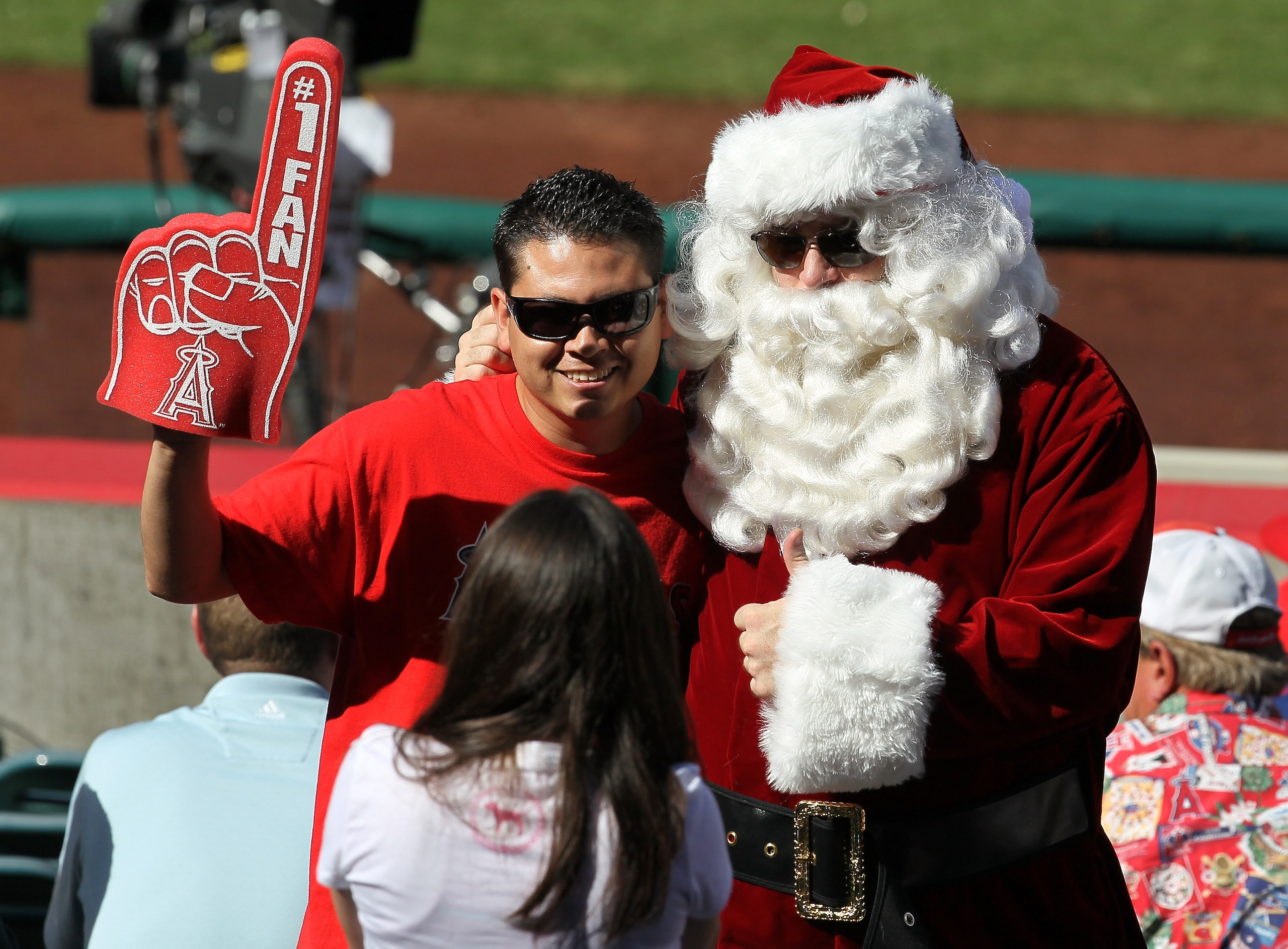 ANAHEIM, CA - SEPTEMBER 29:  A fan gets a photo with a man in a Santa suit attending the game between the Oakland Athletics and the Los Angeles Angels of Anaheim despite a heat wave in Southern California on September 29, 2010 at Angel Stadium in Anaheim,