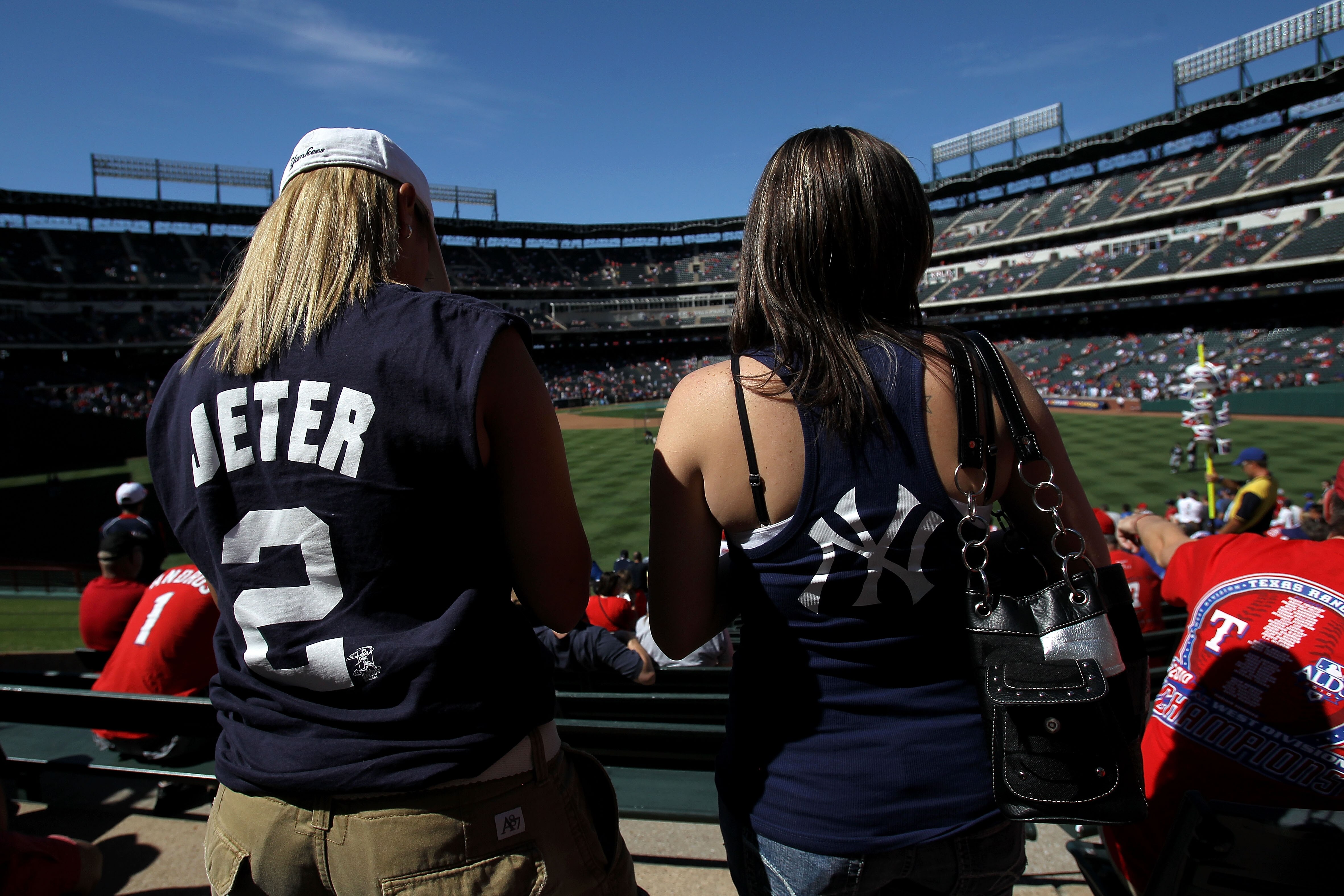 ARLINGTON, TX - OCTOBER 16:  Fans of the New York Yankees watch batting practice against the Texas Rangers in Game Two of the ALCS during the 2010 MLB Playoffs at Rangers Ballpark in Arlington on October 16, 2010 in Arlington, Texas.  (Photo by Ronald Mar