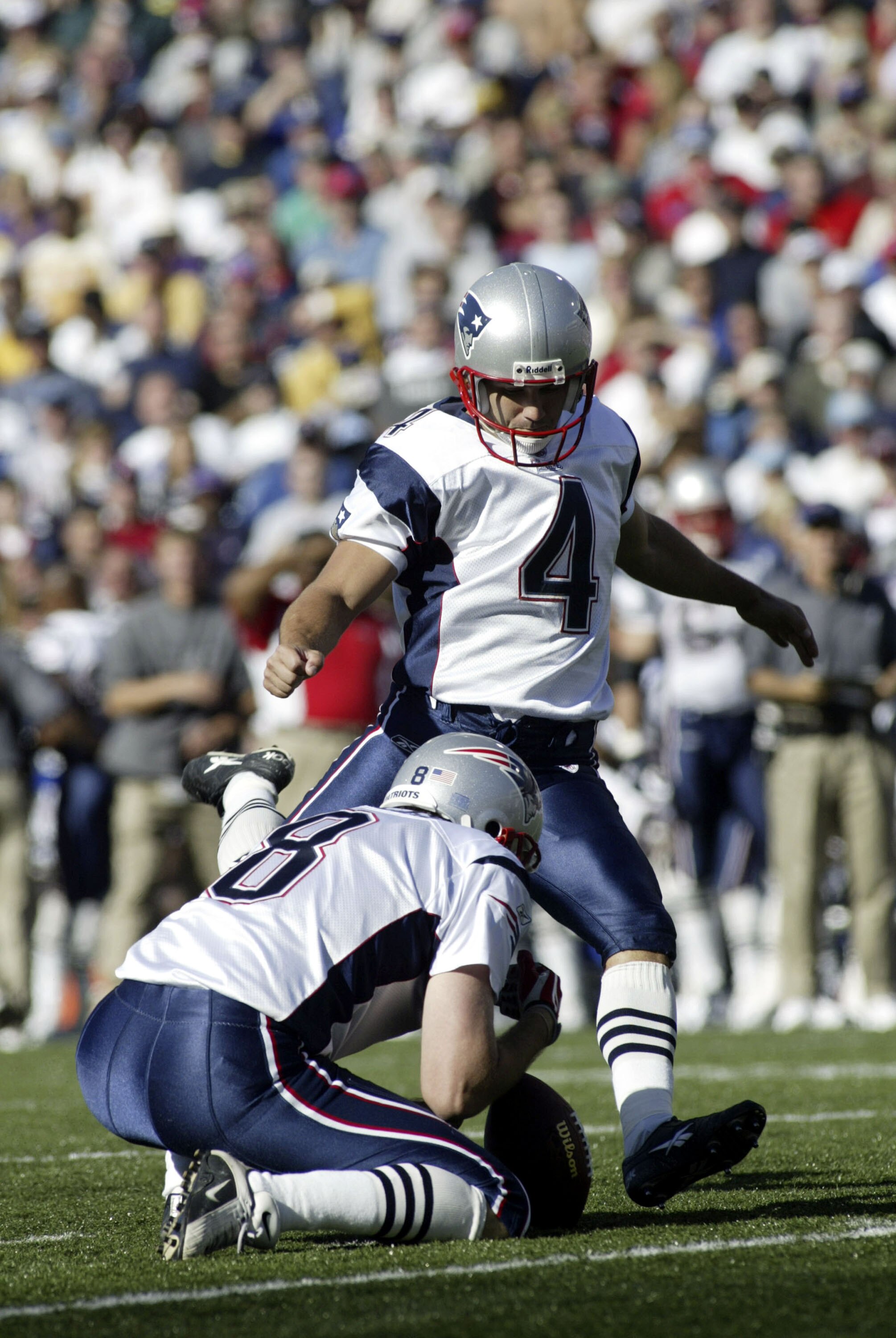 ORCHARD PARK, NY - OCTOBER 3:  Adam Vinitieri #4 of the New England Patriots kicks a 42 yard field goal as Josh Miller #8 holds against the Buffalo Bills on October 3, 2004 at Ralph Wilson Stadium in Orchard Park, New York.  (Photo by Rick Stewart/Getty I