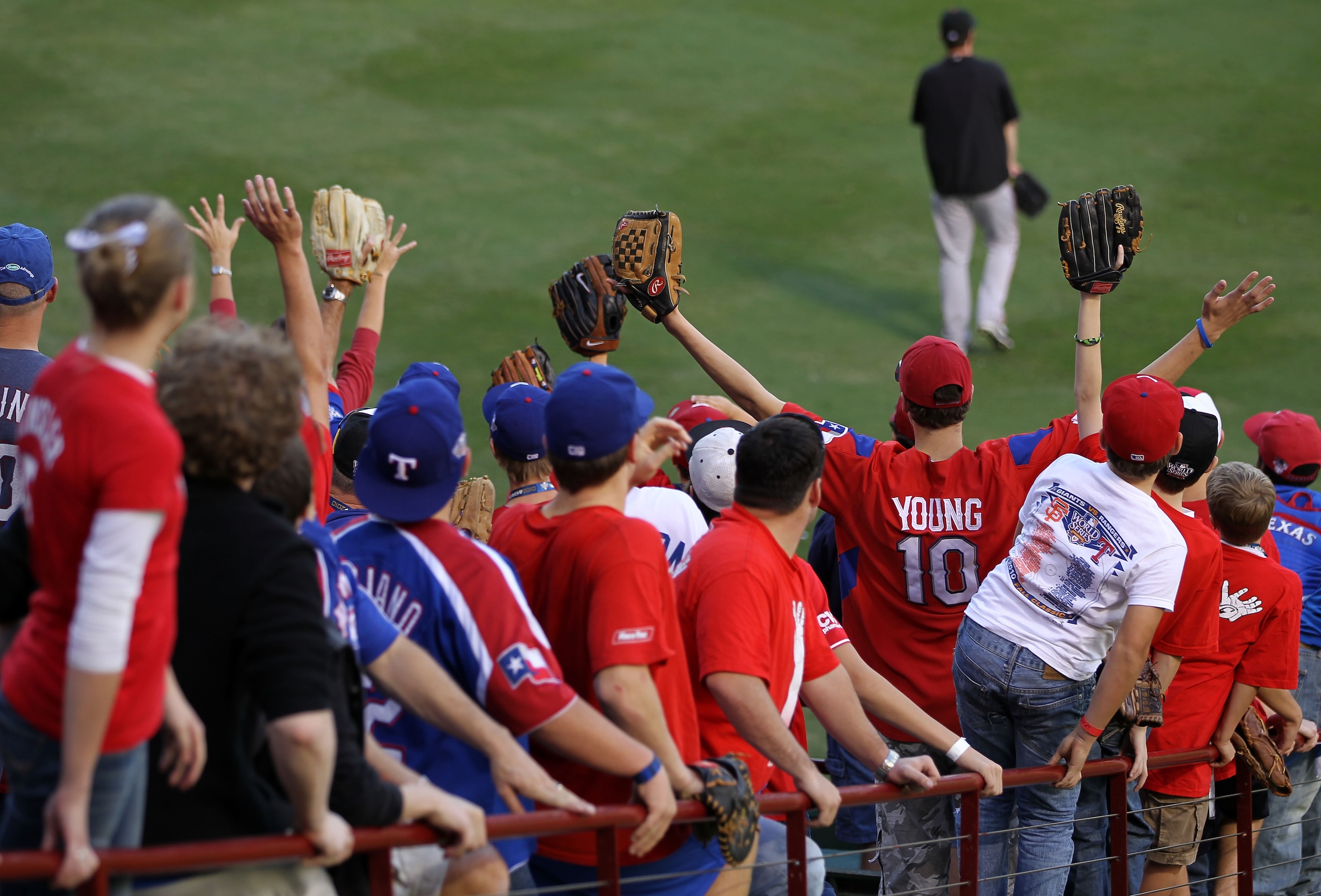 ARLINGTON, TX - OCTOBER 31:  Fans cheer as they wait to catch fly balls during the San Francisco Giants batting practice before the start of Game Four against the Texas Rangers during the 2010 MLB World Series at Rangers Ballpark in Arlington on October 3