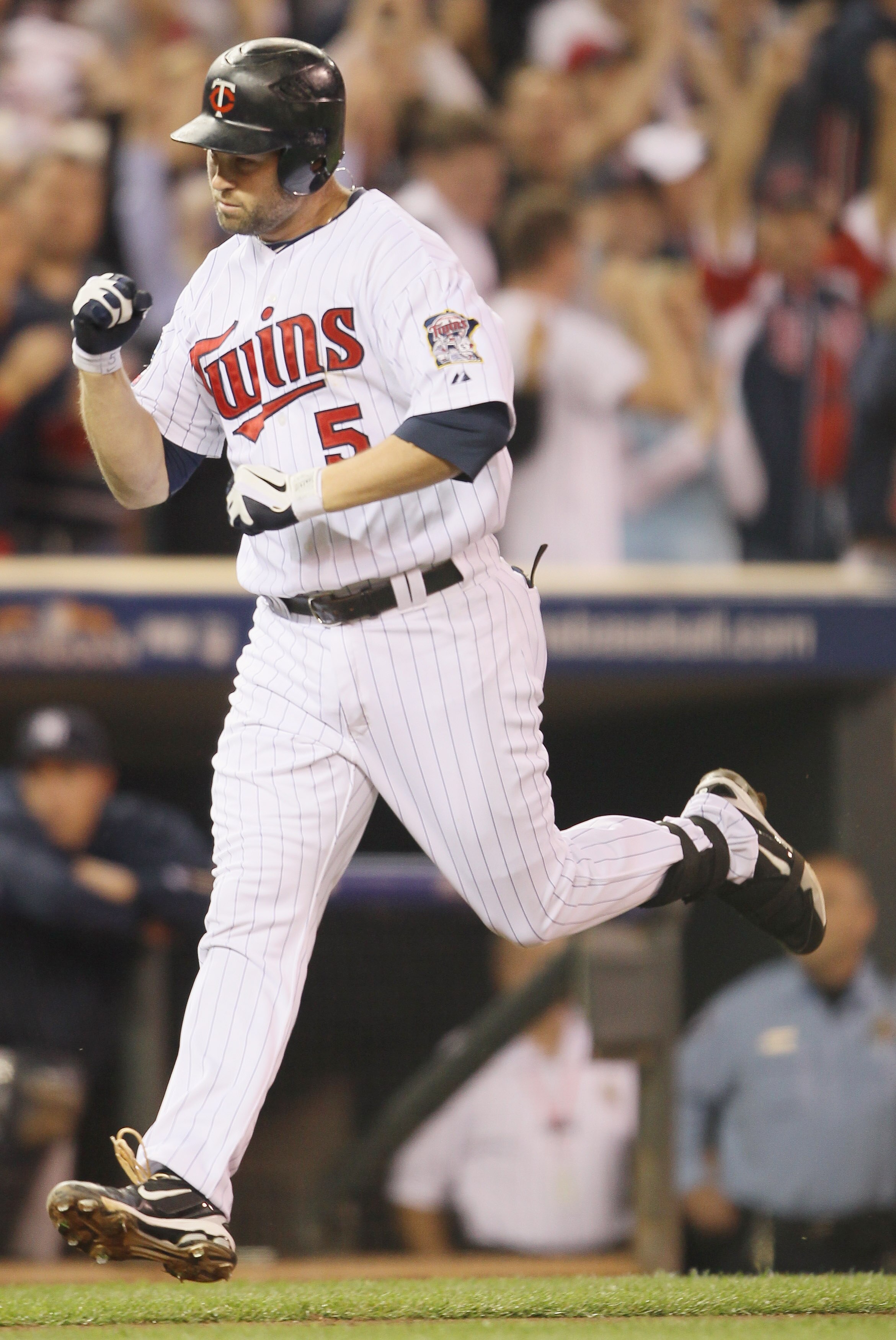 MINNEAPOLIS - OCTOBER 06:  Michael Cuddyer #5 of the Minnesota Twins celebrates his two run homer against the New York Yankees during game one of the ALDS on October 6, 2010 at Target Field in Minneapolis, Minnesota.  (Photo by Elsa/Getty Images)