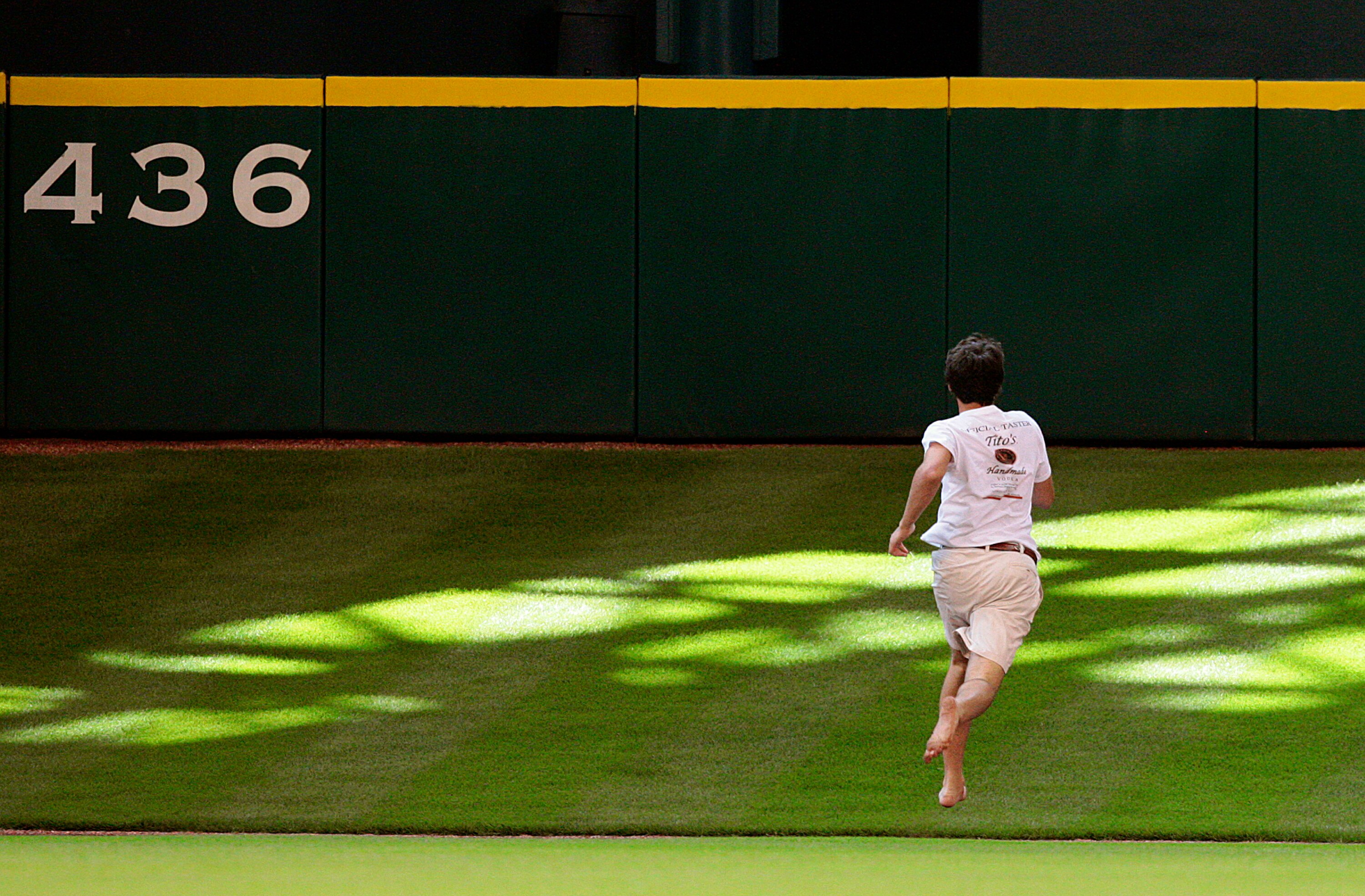 HOUSTON - MAY 31:  A fan runs on the field during the seventh inning during a baseball game between the Washington Nationals and Houston Astros at Minute Maid Park on May 31, 2010 in Houston, Texas.  (Photo by Bob Levey/Getty Images)