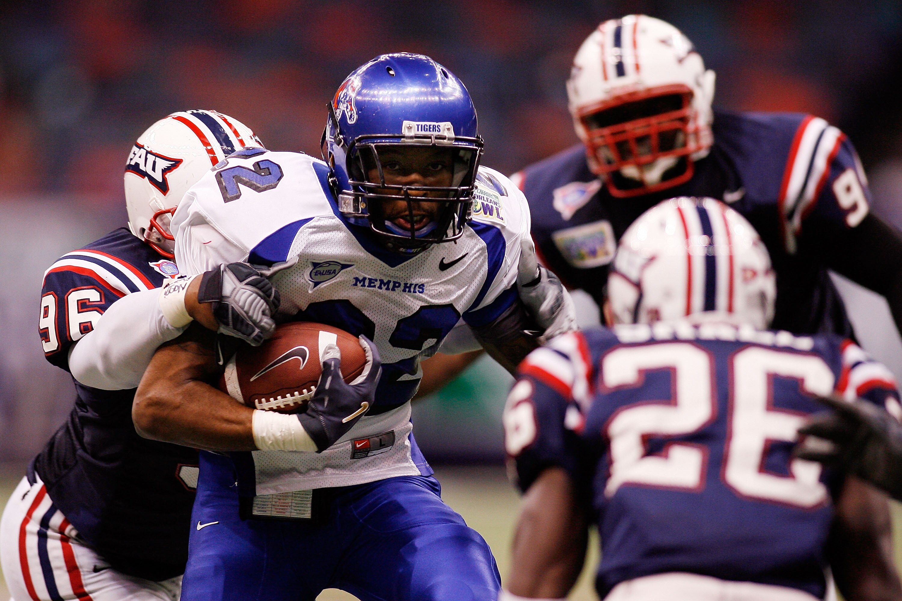 NEW ORLEANS - DECEMBER 21: Duke Calhoun #22 of the Memphis University Tigers is tackled by John Mertilus #96 of the Florida Atlantic University Owls in the R+L Carriers New Orleans Bowl on December 21, 2007 at the Louisiana Superdome in New Orleans, Loui NEW ORLEANS - DECEMBER 21: Duke Calhoun #22 of the Memphis University Tigers is tackled by John Mertilus #96 of the Florida Atlantic University Owls in the R+L Carriers New Orleans Bowl on December 21, 2007 at the Louisiana Superdome in New Orleans, Loui