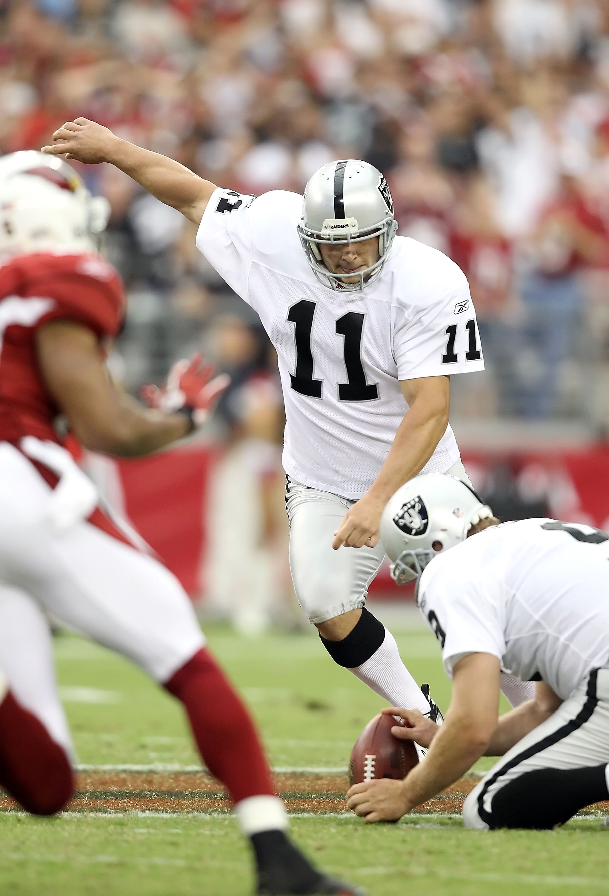 GLENDALE, AZ - SEPTEMBER 26:  Kicker Sebastian Janikowski #11 of the Oakland Raiders attempts a field goal against the Arizona Cardinals during the NFL game at the University of Phoenix Stadium on September 26, 2010 in Glendale, Arizona. The Cardinals def
