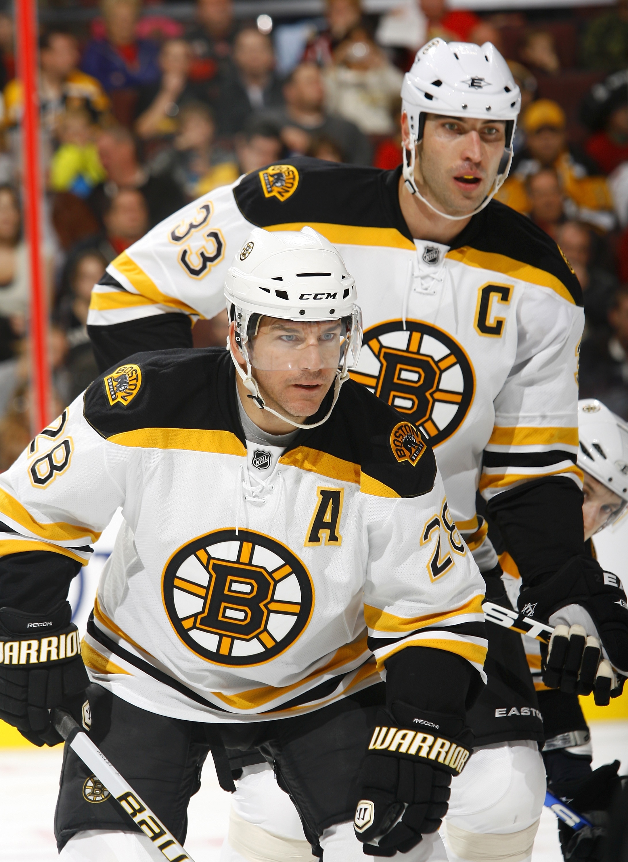 OTTAWA, ON - OCTOBER 30:  Zdeno Chara #33 of the Boston Bruins towers over teammate Mark Recchi #28 at a faceoff during a game against the Ottawa Senators at Scotiabank Place on October 30, 2010 in Ottawa, Ontario, Canada.  The Boston Bruins defeated the