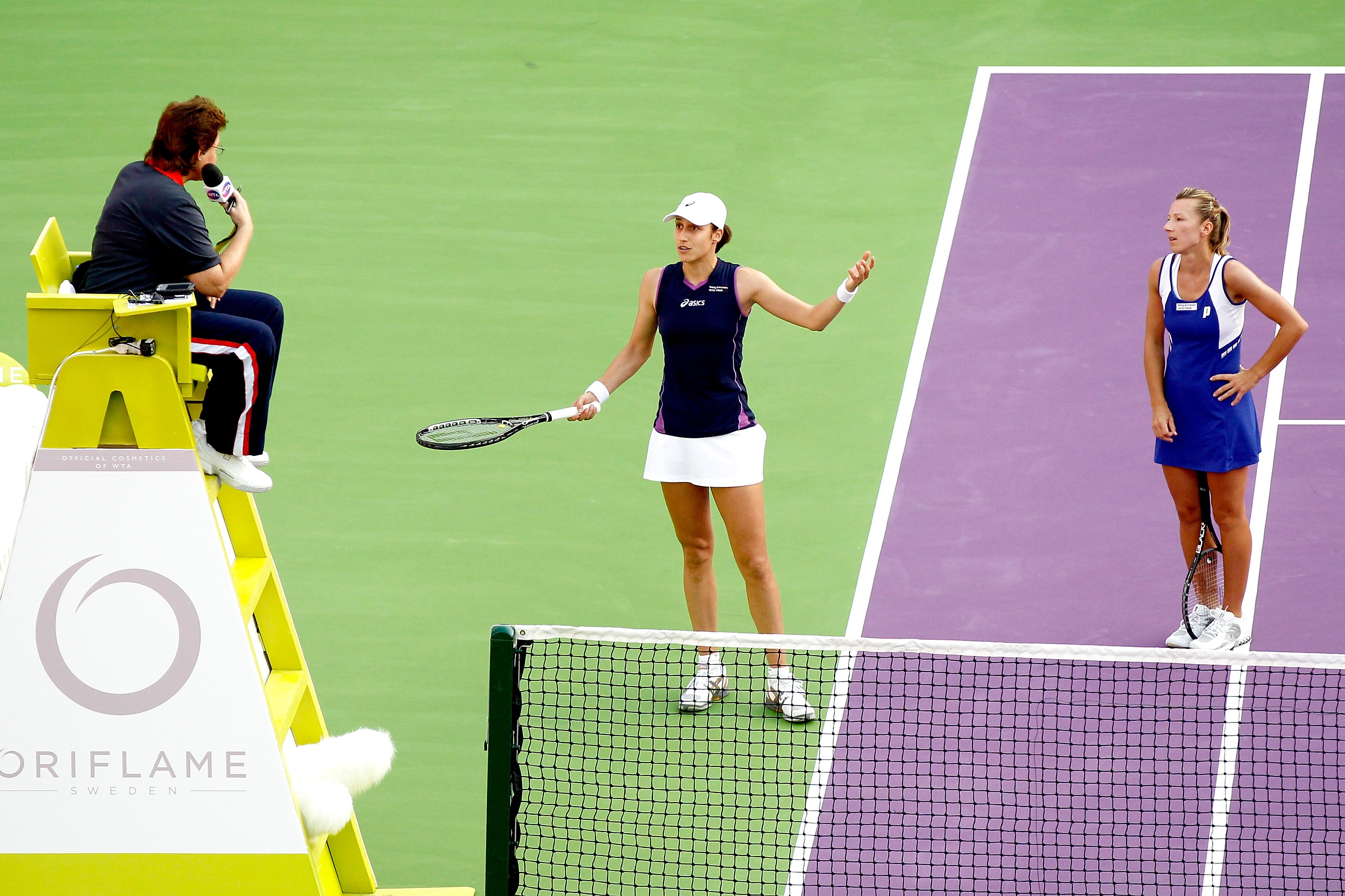 DOHA, QATAR - OCTOBER 30:  Katarina Srebotnik (C) of Slovenia and Kveta Peschke (R) of the Czech Republic dispute a call with chair umpire Lynn Welsh of the United States while playing Lisa Raymond of the United States and Rennae Stubbs of Australia durin