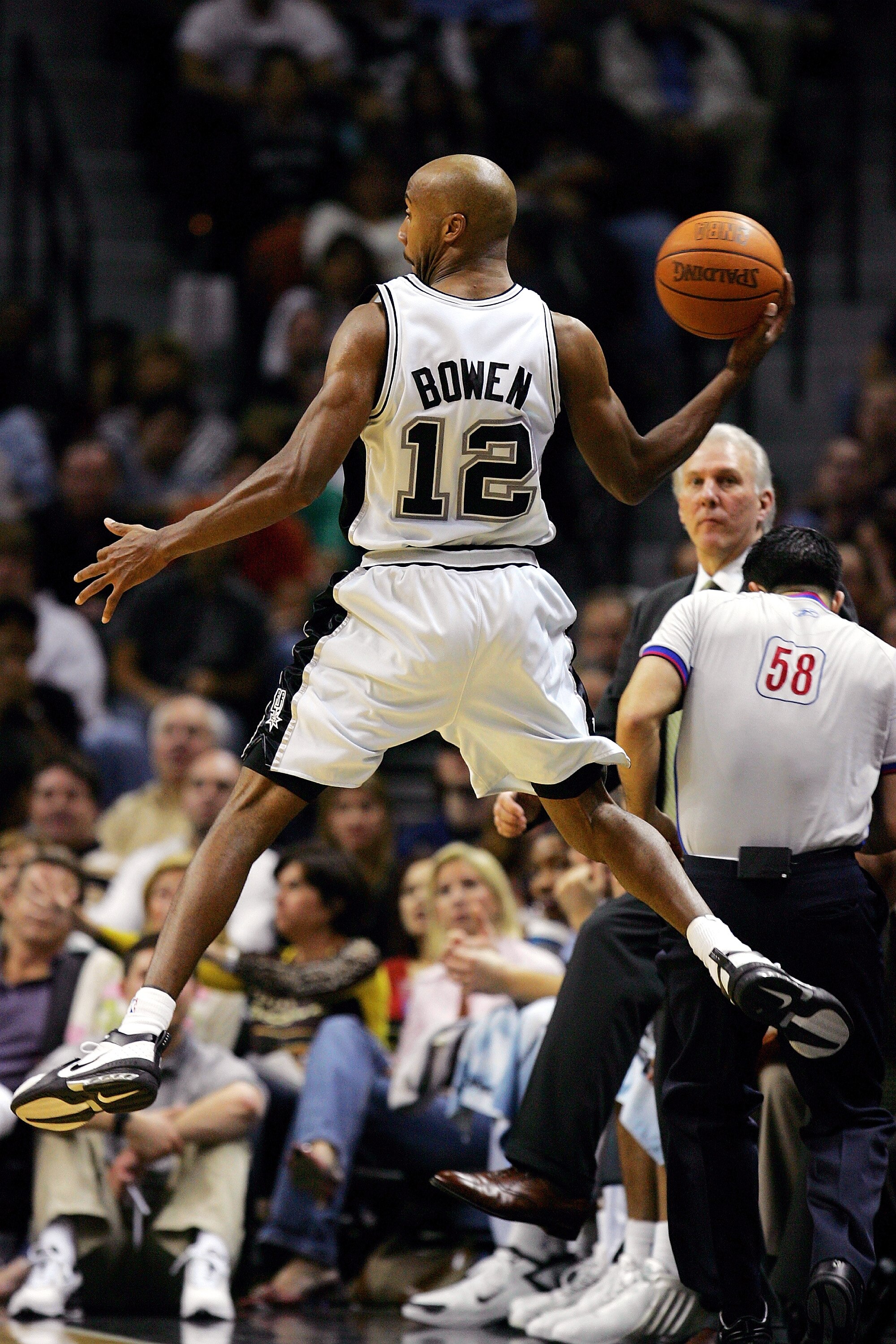 SAN ANTONIO - JANUARY 4:  Forward Bruce Bowen #12 of the San Antonio Spurs throws the ball while falling out of bounds against the Los Angeles Lakers on January 4, 2005 at the SBC Center in San Antonio, Texas.  NOTE TO USER: User expressly acknowledges an