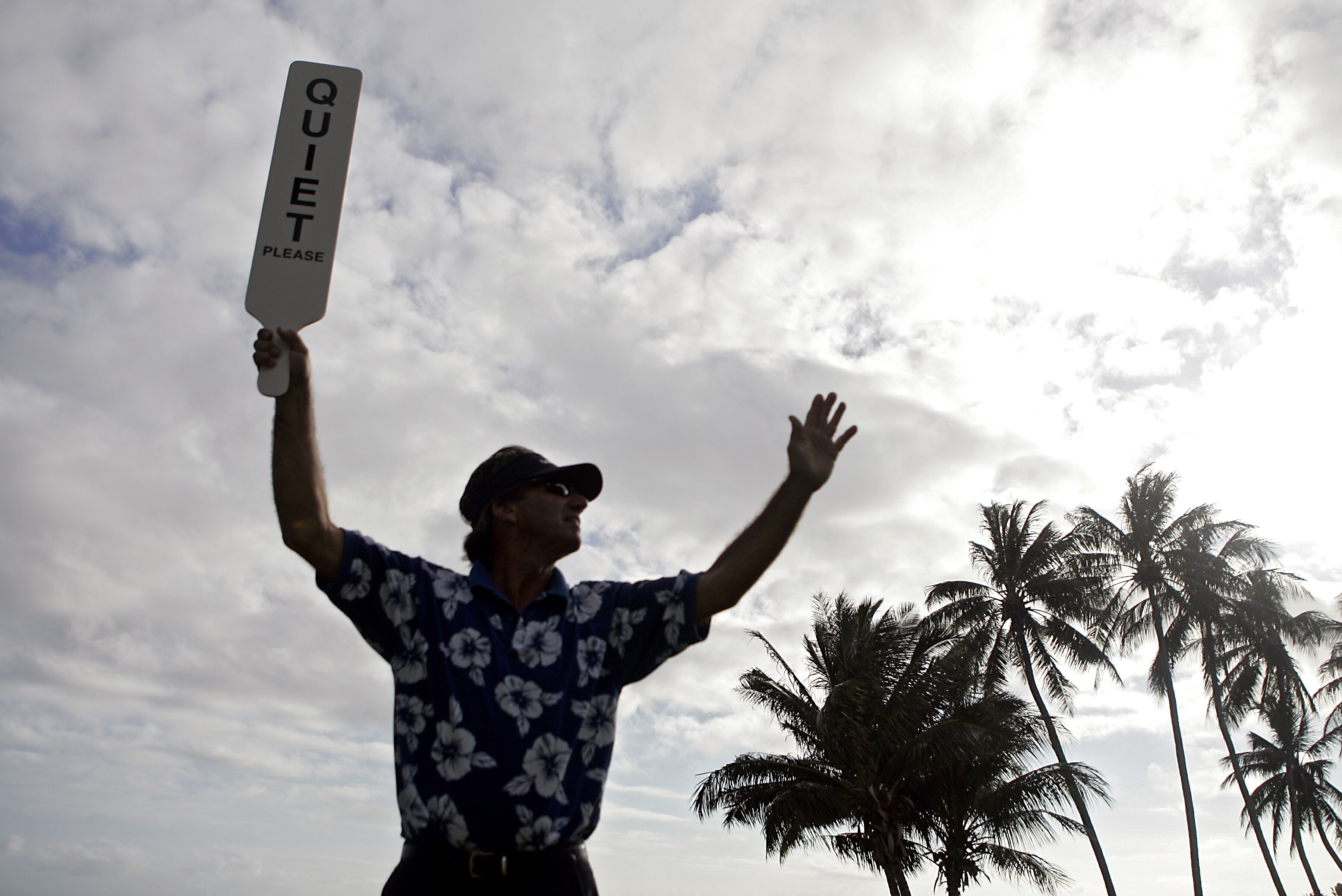 UNITED STATES - JANUARY 11:  A volunteer holds up a 'QUIET' sign on the 17th tee during the first round of the Sony Open held at the Waialae Country Club in Honolulu, Hawaii on January 11, 2007.  (Photo by Marco Garcia/Getty Images)