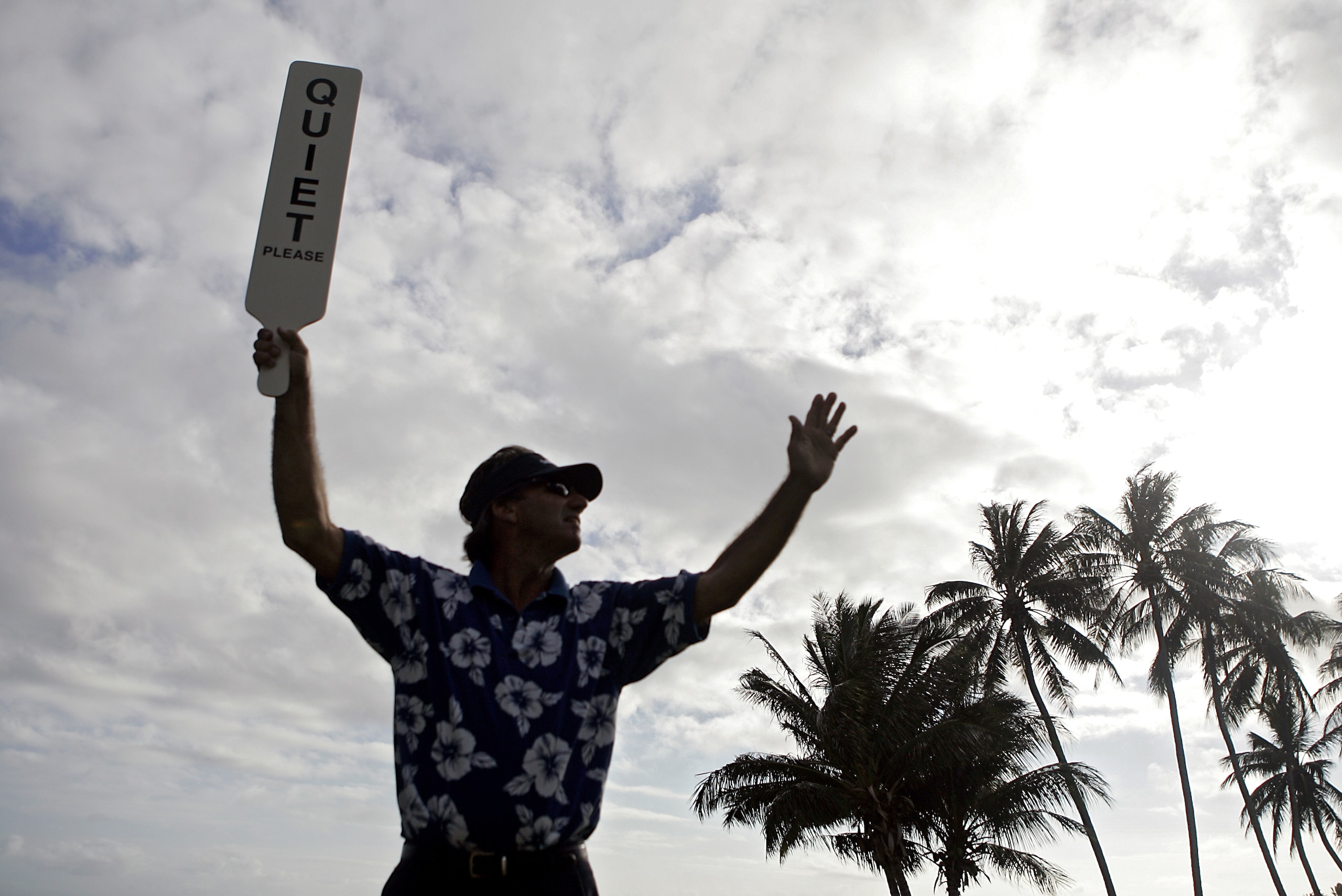 UNITED STATES - JANUARY 11:  A volunteer holds up a 'QUIET' sign on the 17th tee during the first round of the Sony Open held at the Waialae Country Club in Honolulu, Hawaii on January 11, 2007.  (Photo by Marco Garcia/Getty Images)