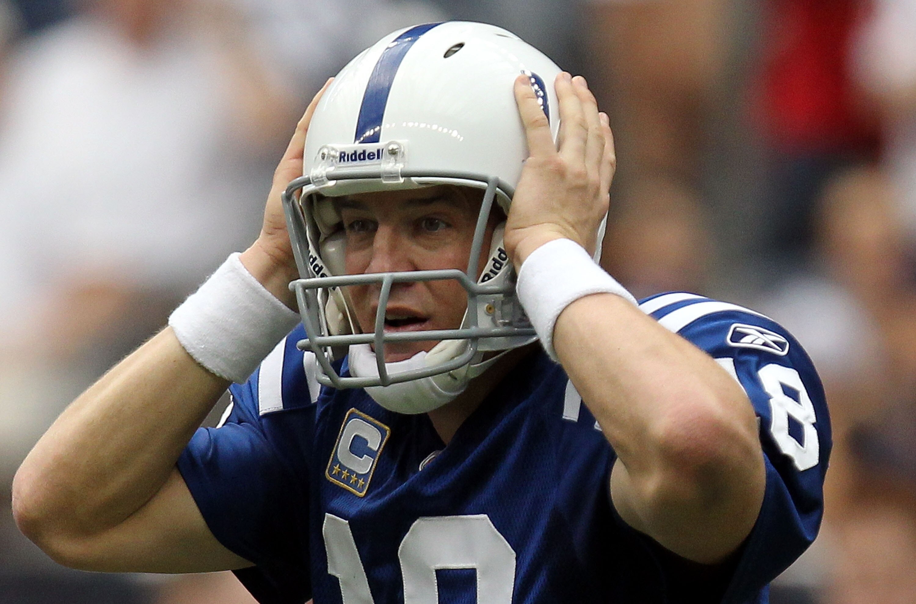 HOUSTON - SEPTEMBER 12:  Quarterback Peyton Manning #18 of the Indianapolis Colts grabs his helmet during the NFL season opener against the Houston Texans at Reliant Stadium on September 12, 2010 in Houston, Texas.  (Photo by Ronald Martinez/Getty Images)