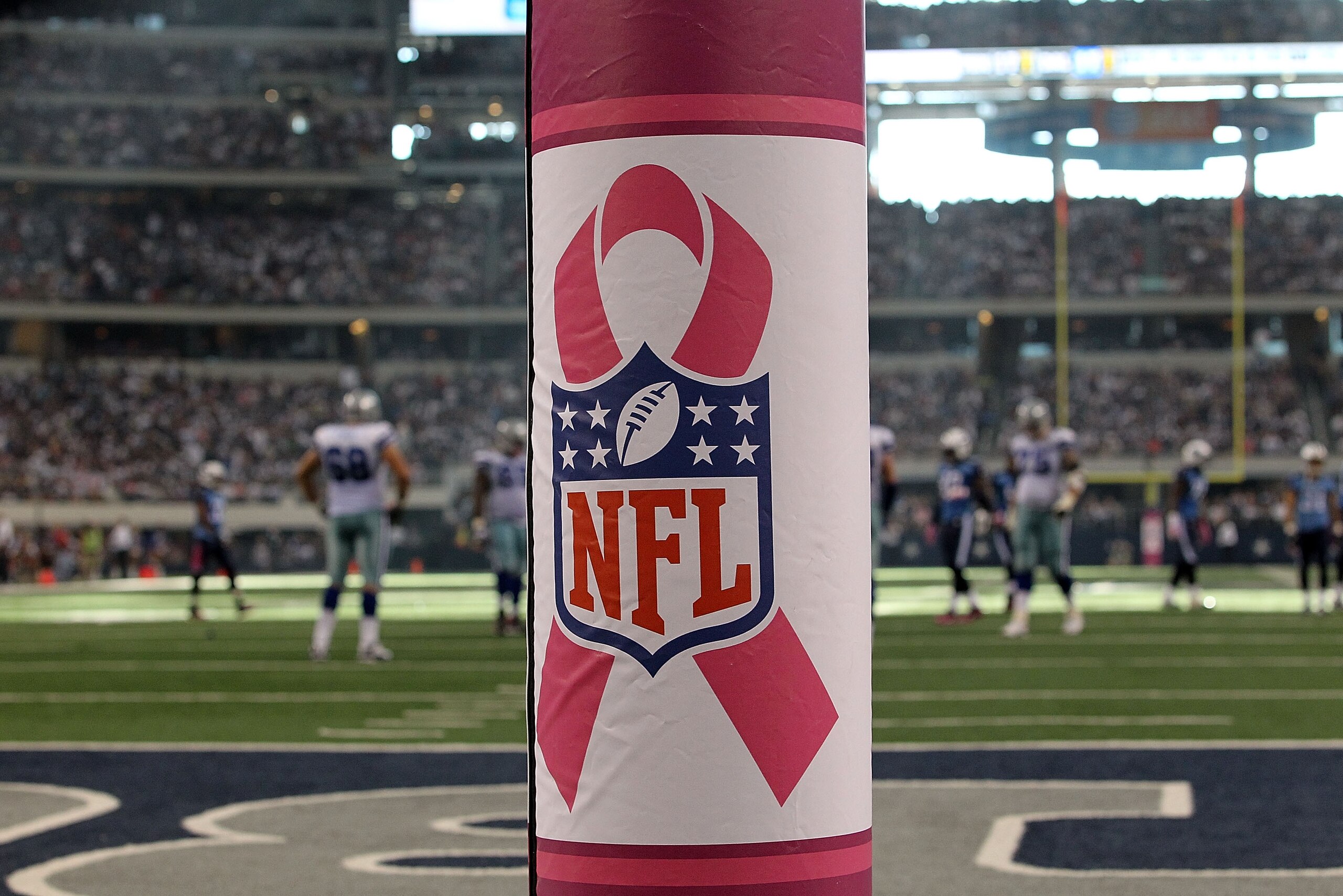 ARLINGTON, TX - OCTOBER 10:  A pink ribbon with the NFL logo in support of Breast Cancer Awareness on the goal post during a game between the Tennessee Titans and Dallas Cowboys at Cowboys Stadium on October 10, 2010 in Arlington, Texas.  (Photo by Ronald