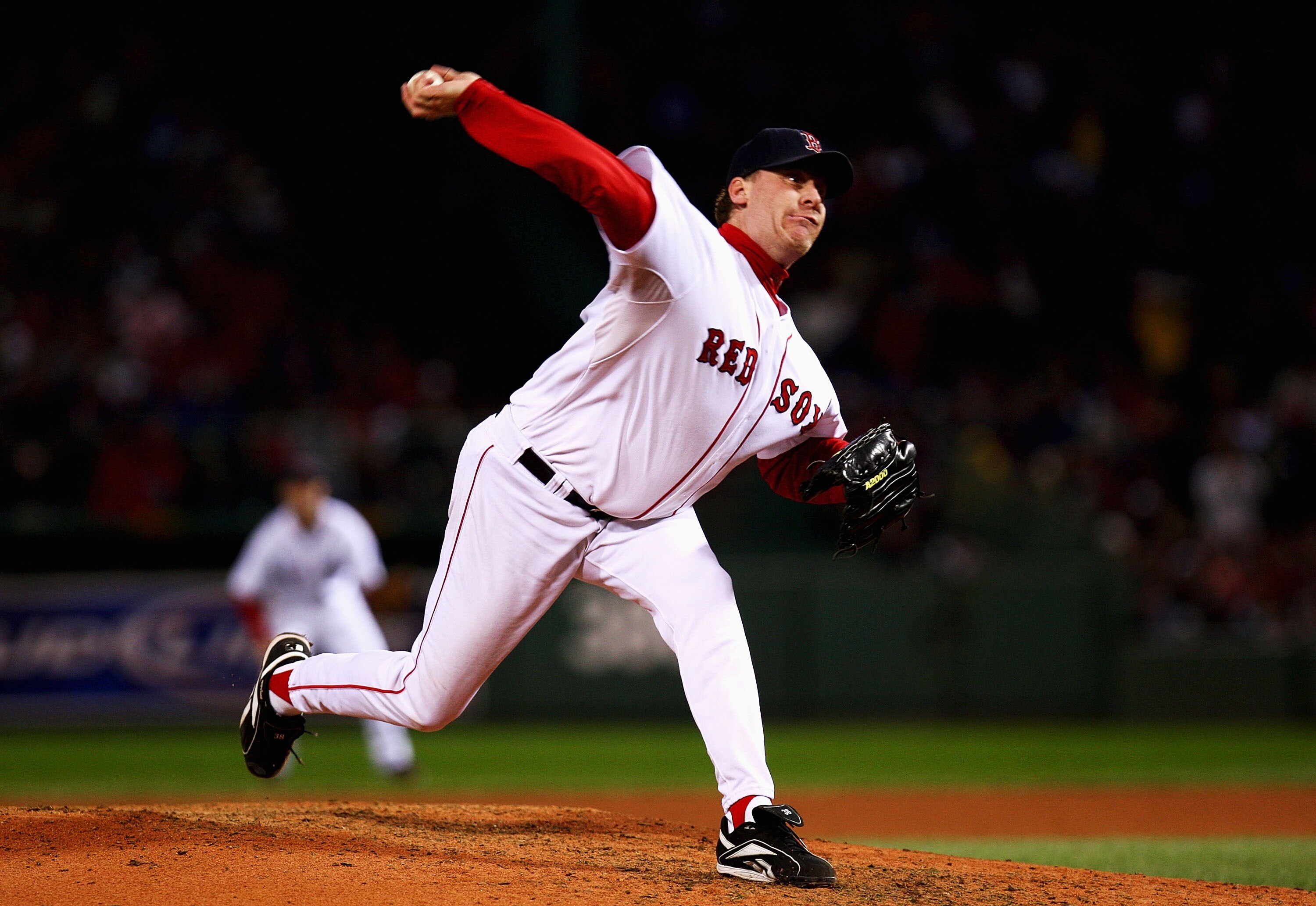 BOSTON - OCTOBER 13:  Starting pitcher Curt Schilling #38 of the Boston Red Sox pitches in the first inning of Game Two of the American League Championship Series against the Cleveland Indians at Fenway Park on October 13, 2007 in Boston, Massachusetts.  