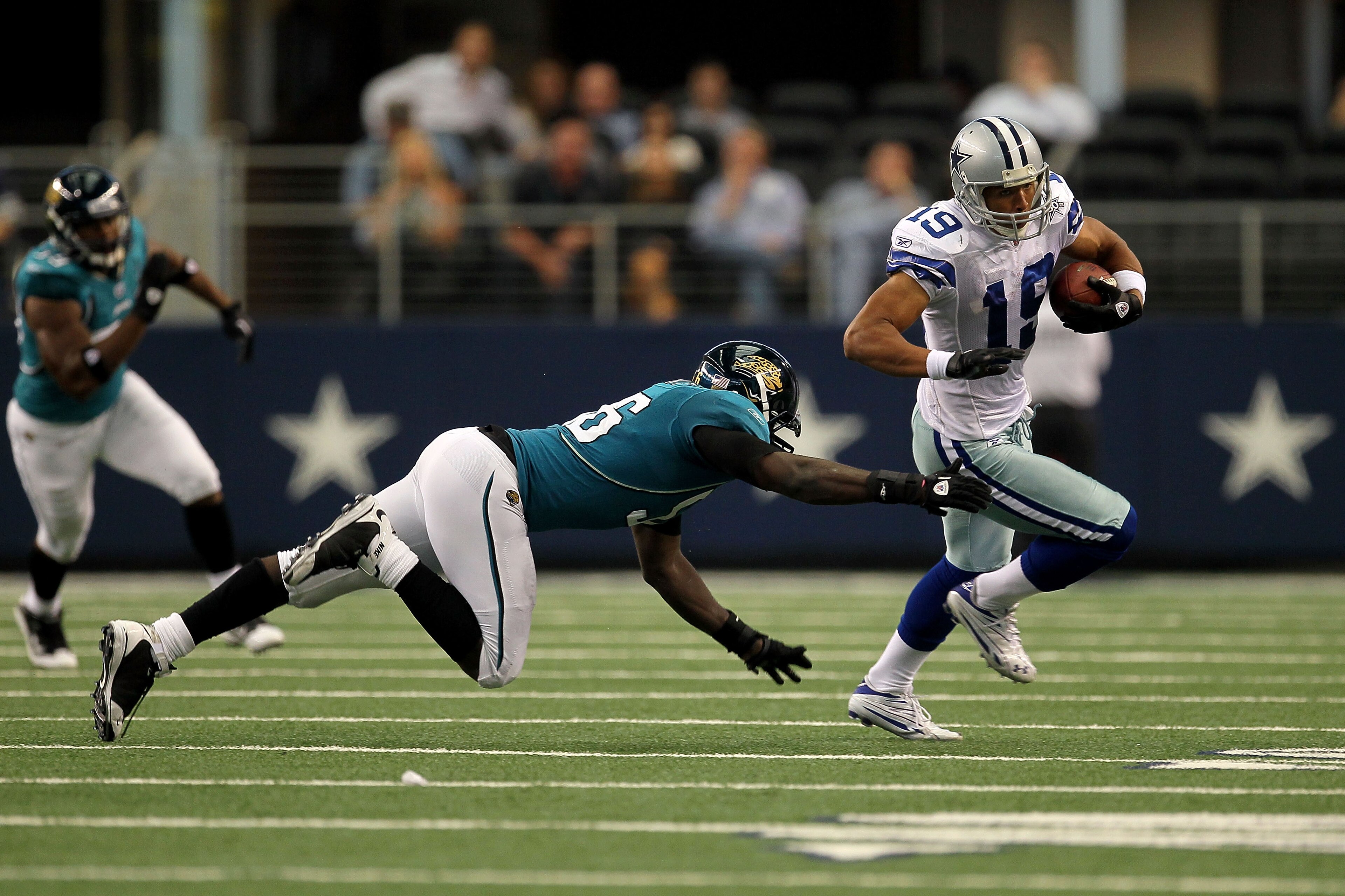 ARLINGTON, TX - OCTOBER 31:  Miles Austin #19 of the Dallas Cowboys runs for yards after the catch in the first half against Justin Durant #56 of the Jacksonville Jaguars at Cowboys Stadium on October 31, 2010 in Arlington, Texas.  (Photo by Stephen Dunn/