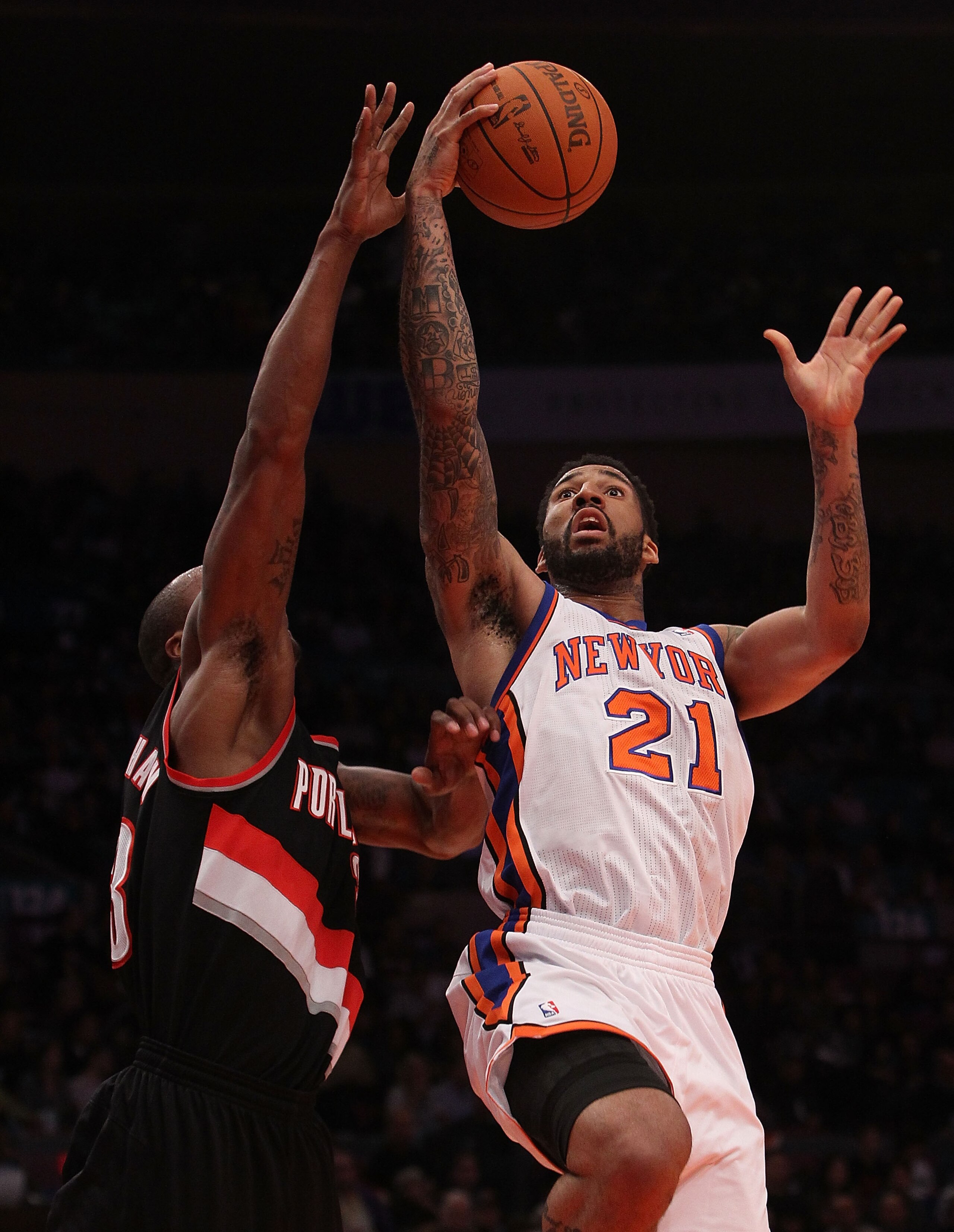 NEW YORK - OCTOBER 30: Wilson Chandler #21 of the New York Knicks lays the ball up against Dante Cunningham #33 of the Portland Trail Blazers at Madison Square Garden on October 30, 2010 in New York City. NOTE TO USER: User expressly acknowledges and agre