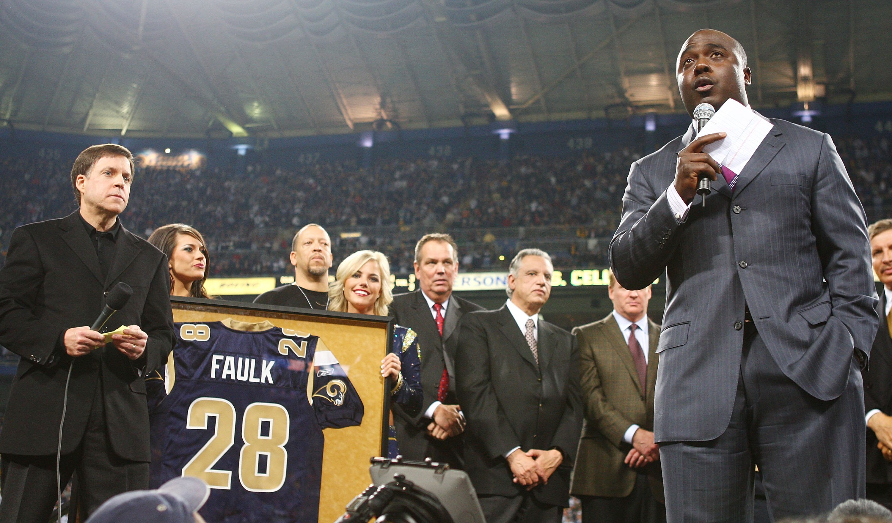 ST. LOUIS - DECEMBER 20:   Former running back Marshall Faulk of the St. Louis Rams addresses the fans during a halftime ceremony to retire his jersey on December 20, 2007 at Edward Jones Dome in St. Louis, Missouri.  (Photo by Elsa/Getty Images)