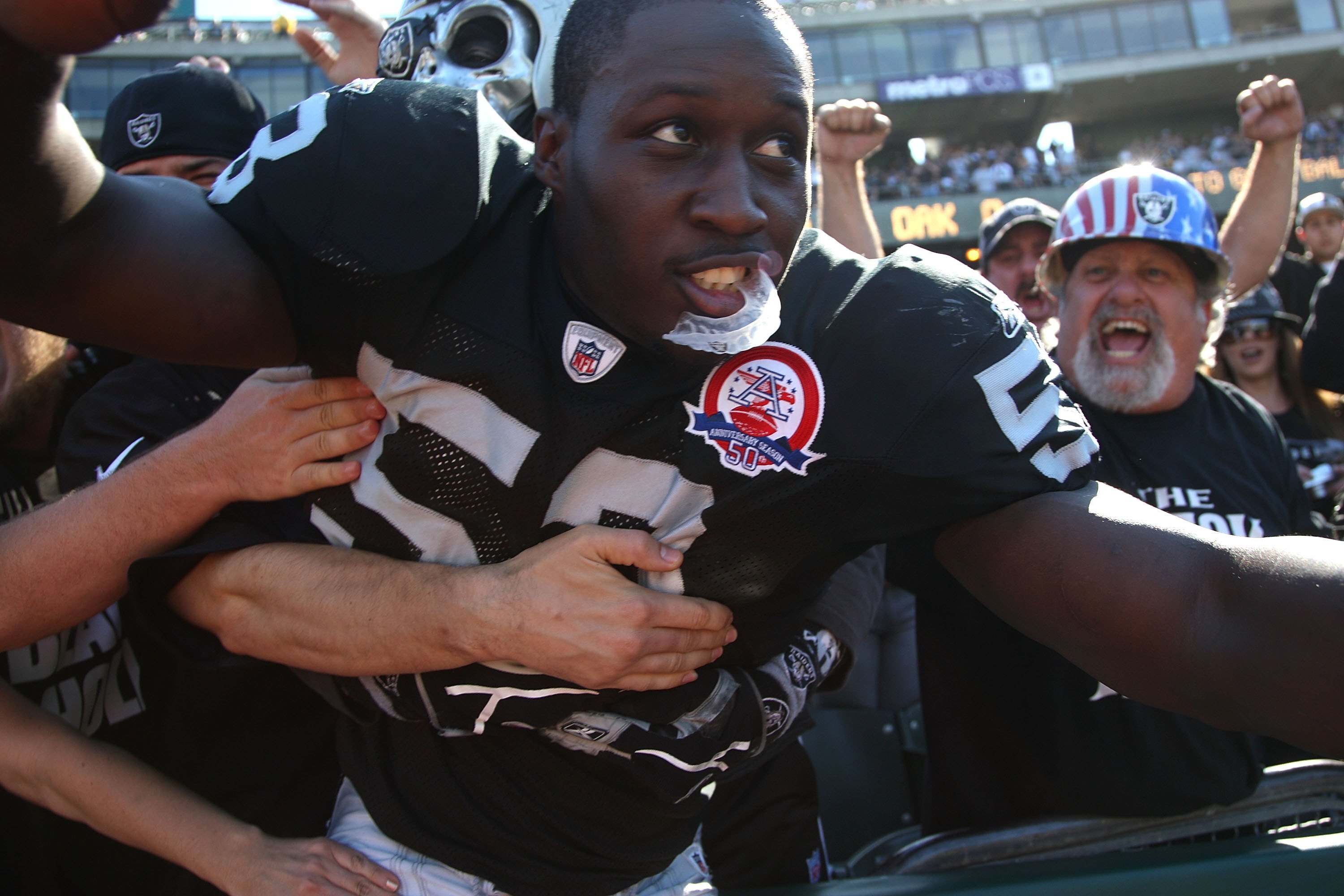 OAKLAND, CA - OCTOBER 25:  Kirk Morrison #52 of the Oakland Raiders celebrates with fans against the New York Jets during an NFL game at the Oakland-Alameda County Coliseum on October 25, 2009 in Oakland, California.  (Photo by Jed Jacobsohn/Getty Images)