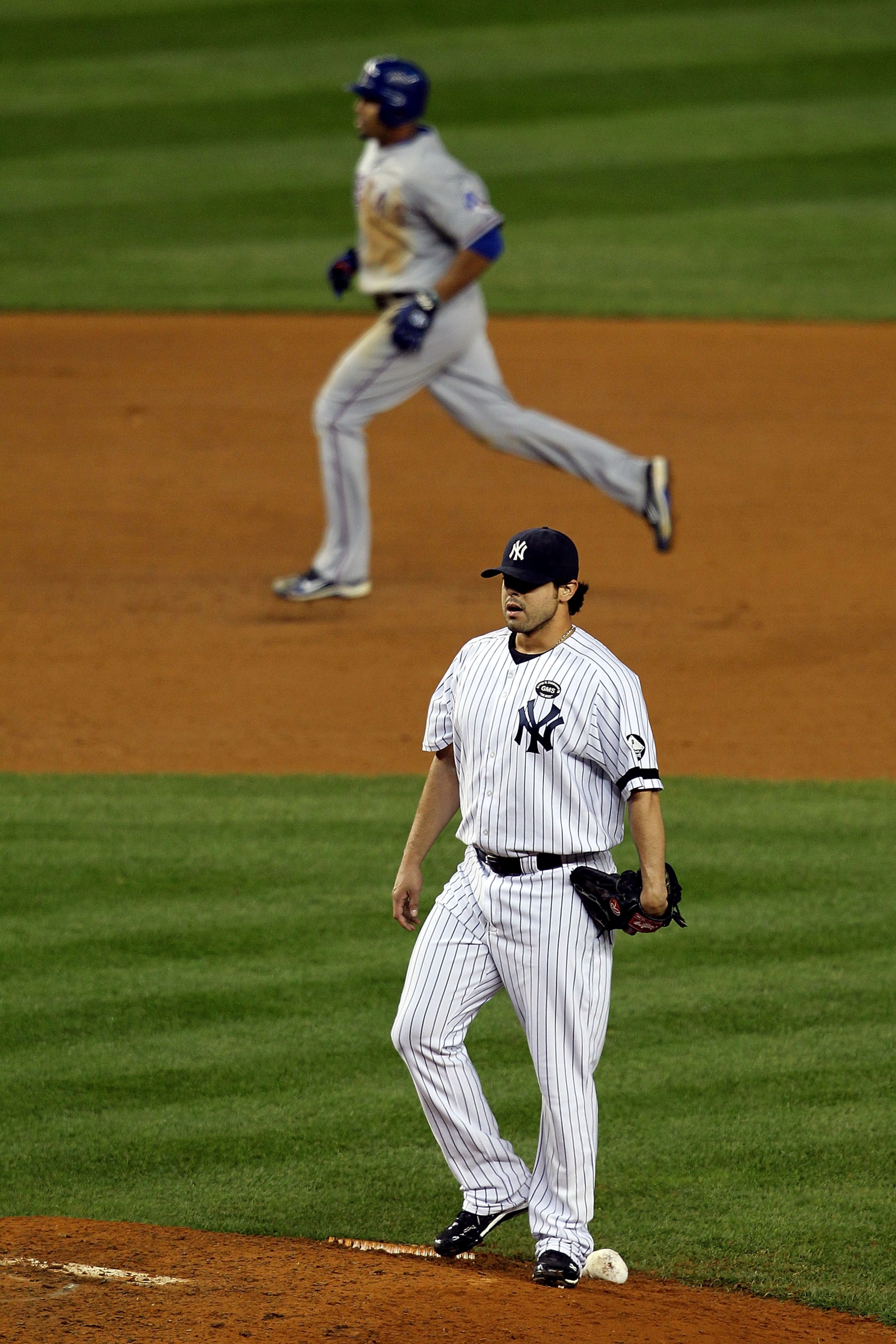 NEW YORK - OCTOBER 19:  Nelson Cruz #17 of the Texas Rangers runs the bases on his 2-run home run in the bottom of the ninth inning against Sergio Mitre #45 of the New York Yankees  in Game Four of the ALCS during the 2010 MLB Playoffs at Yankee Stadium o
